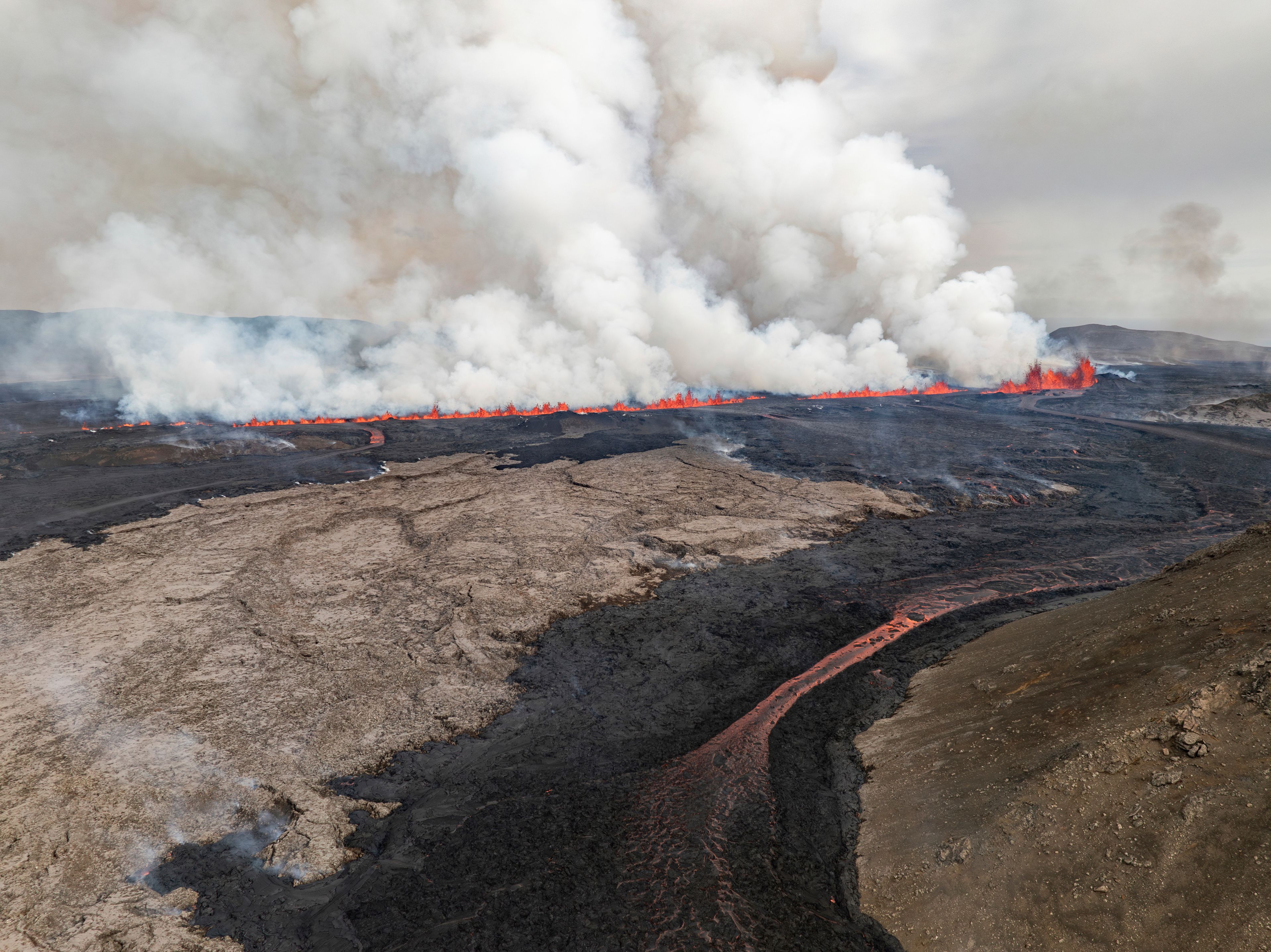 An eruptive fissure spews lava and smoke from a volcano in Grindavik, Iceland, Wednesday, May 29, 2024. A volcano in southwestern Iceland erupted Wednesday for the fifth time since December, spewing red lava that once again threatened the coastal town of Grindavik and led to the evacuation of the popular Blue Lagoon geothermal spa.