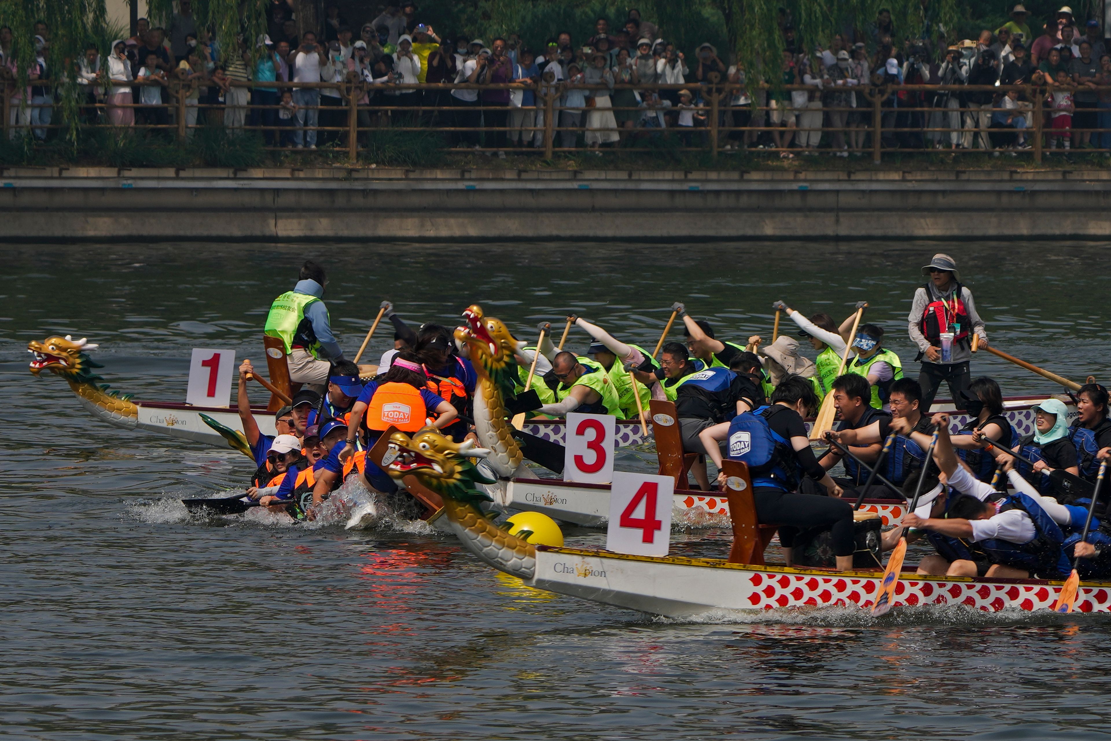 Teams of dragon boat racers crash after one of the boats paddled off direction during the Dragon Boat Festival at a canal in Tongzhou, outskirts of Beijing, Monday, June 10, 2024. The Duanwu Festival, also known as the Dragon Boat Festival, falls on the fifth day of the fifth month of the Chinese lunar calendar and is marked by eating rice dumplings and racing dragon boats.