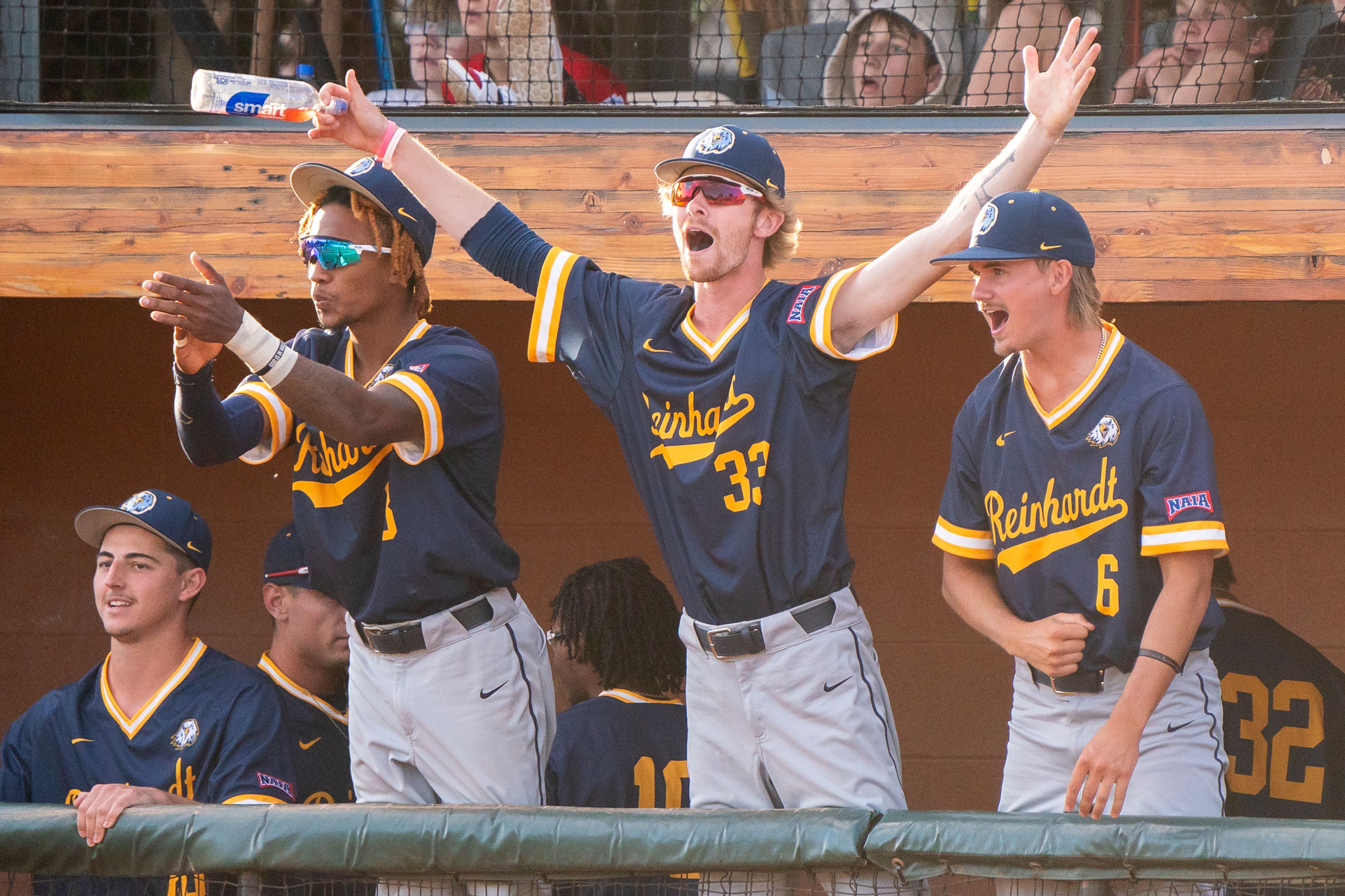 The Reinhardt dugout celebrates during Game 18 of the NAIA World Series against Tennessee Wesleyan on Thursday at Harris Field in Lewiston.