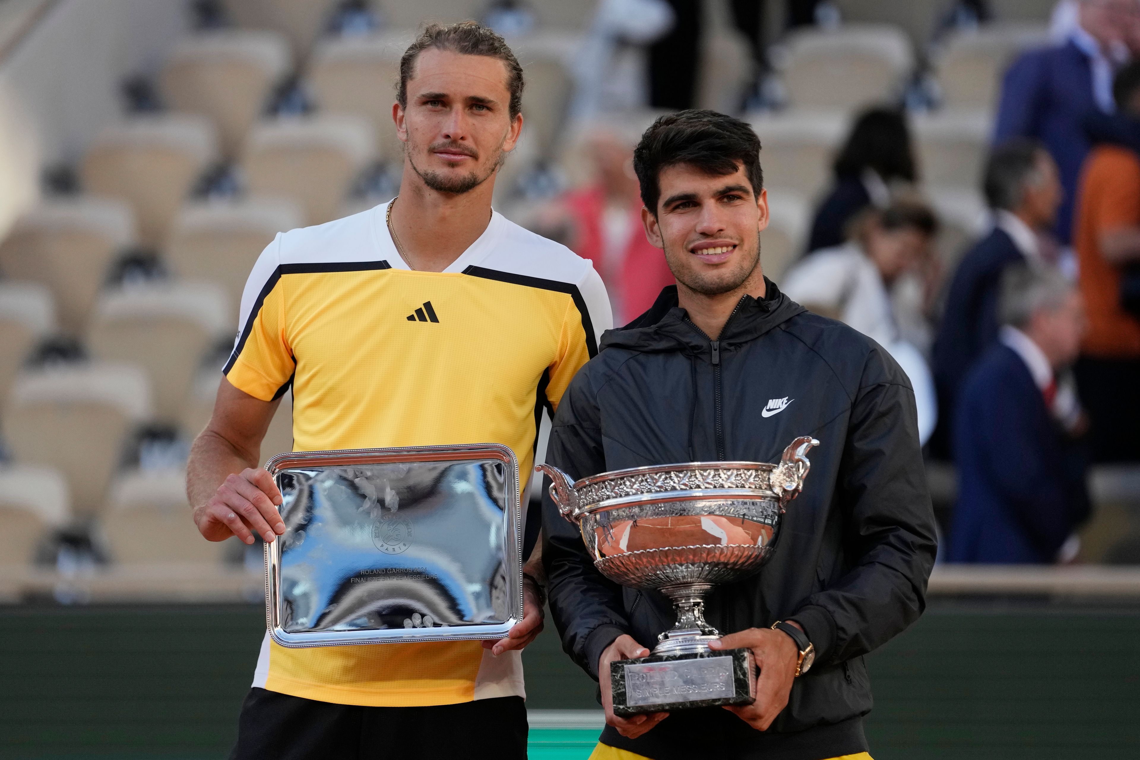 Winner Spain's Carlos Alcaraz, right, and second placed Germany's Alexander Zverev pose with their trophies after the men's final match of the French Open tennis tournament at the Roland Garros stadium in Paris, Sunday, June 9, 2024.