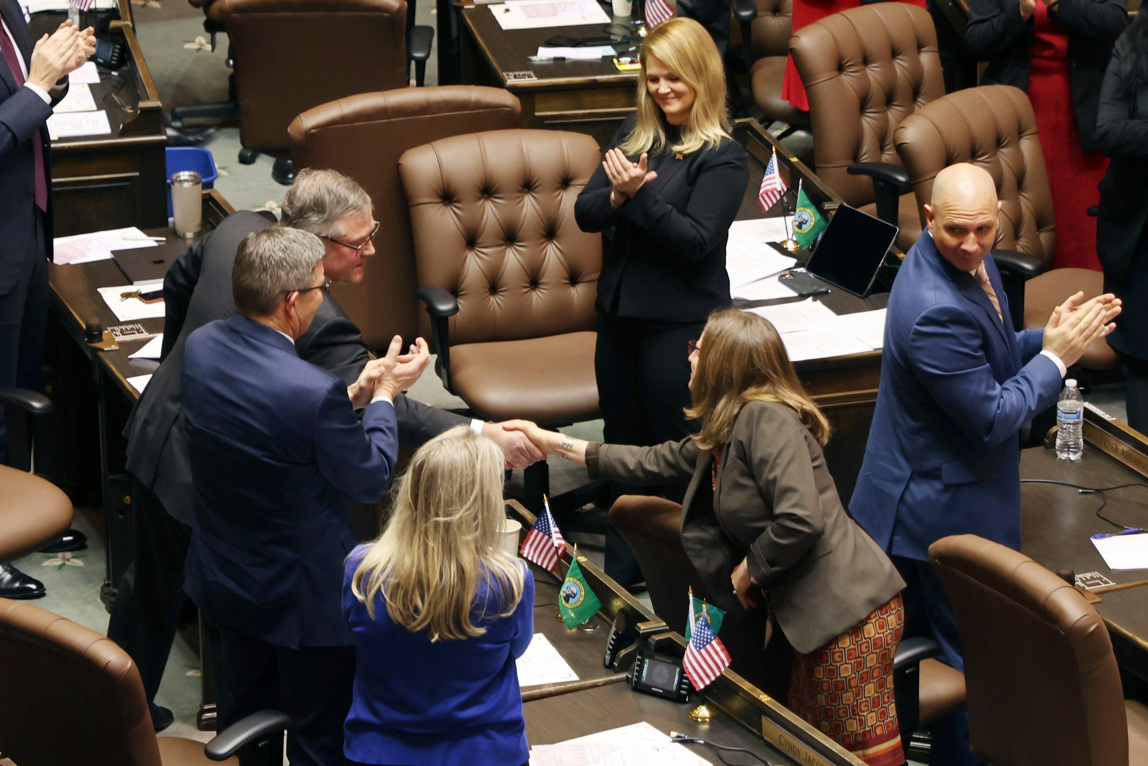 House Republican leader J.T. Wilcox shakes hands with Rep Tana Senn after addressing legislators on the first day of the legislative session at the Washington state Capitol in Olympia, Wash., on Monday, Jan. 9, 2023. (Karen Ducey/The Seattle Times via AP)