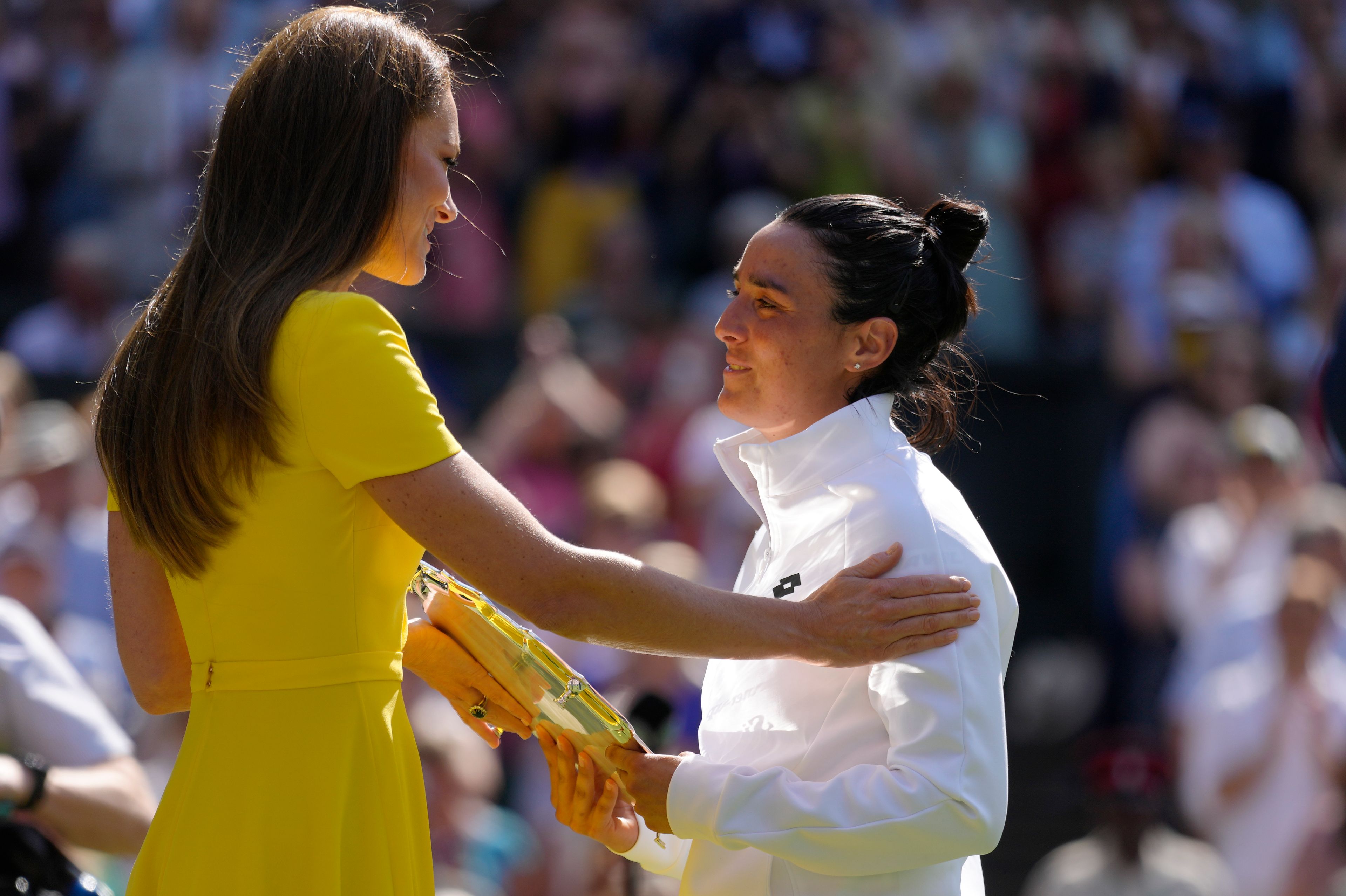 Britain's Kate, Duchess of Cambridge consoles Tunisia's Ons Jabeur after she lost to Kazakhstan's Elena Rybakina in the final of the women's singles on day thirteen of the Wimbledon tennis championships in London, Saturday, July 9, 2022. (AP Photo/Kirsty Wigglesworth)