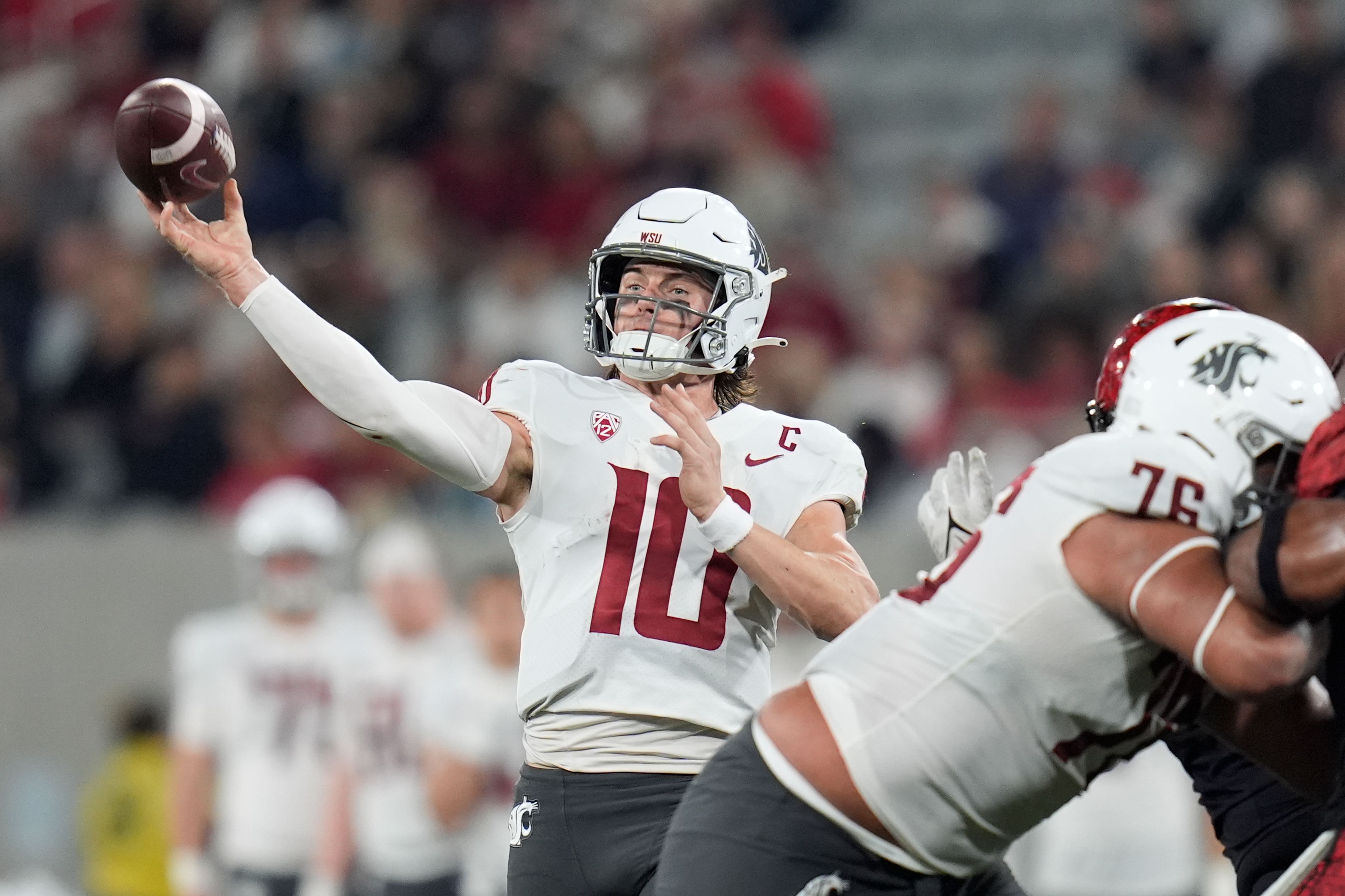 Washington State quarterback John Mateer throws a pass during the first half of an NCAA college football game against San Diego State Saturday, Oct. 26, 2024, in San Diego. (AP Photo/Gregory Bull)