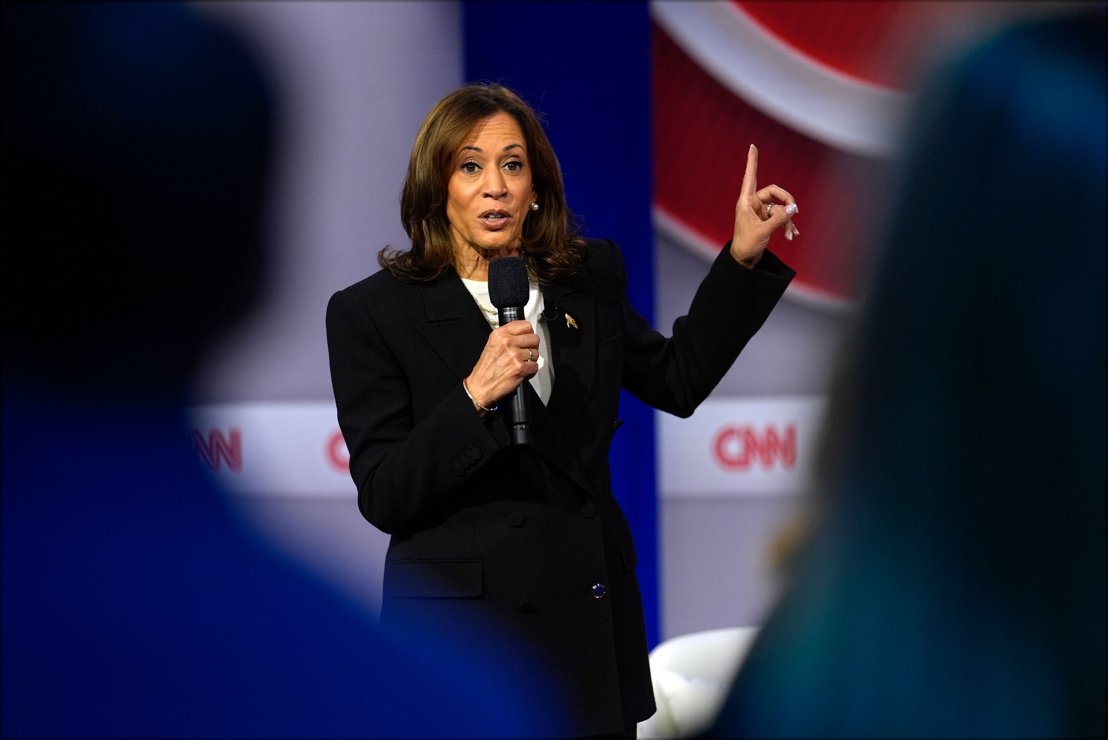 Democratic presidential nominee Vice President Kamala Harris speaks during a CNN town hall in Aston, Pa., Wednesday, Oct. 23, 2024, as moderator Anderson Cooper listens. (AP Photo/Matt Rourke)