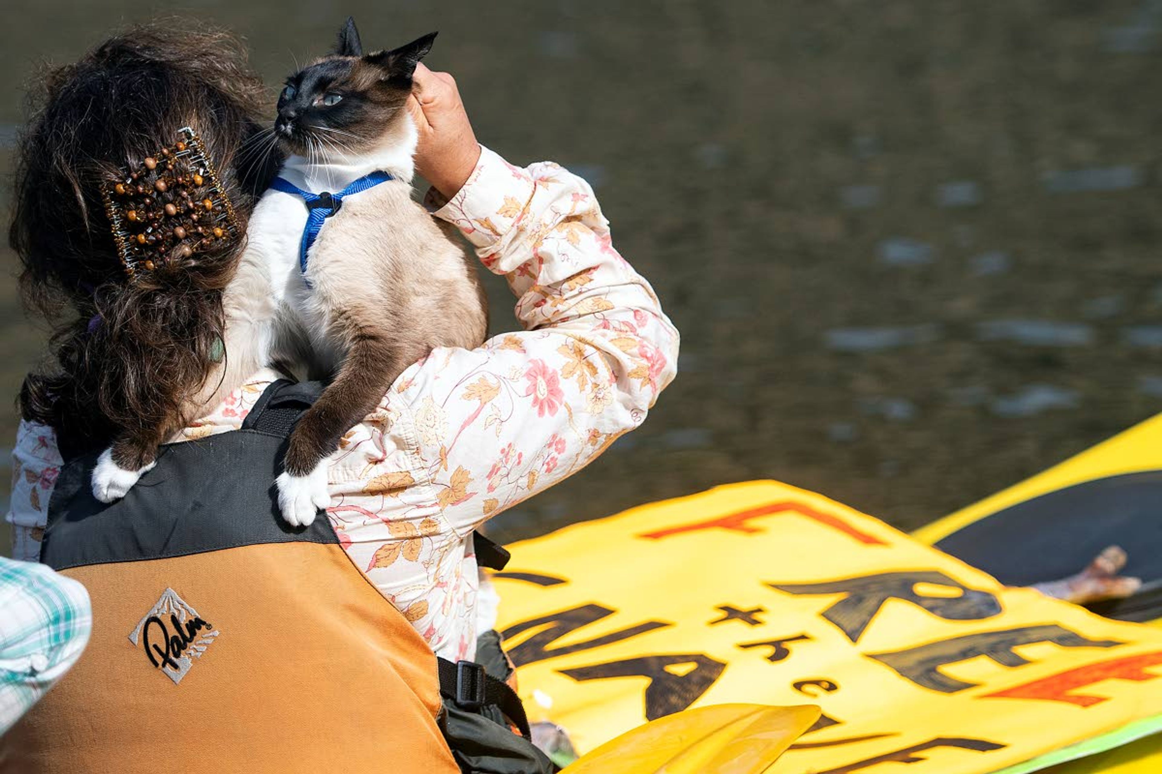 A woman puts her cat onto her shoulder as she sets off in a kayak from the Asotin Boat Launch on Saturday morning as part of the Nimiipuu River Rendezvous along the Snake River.