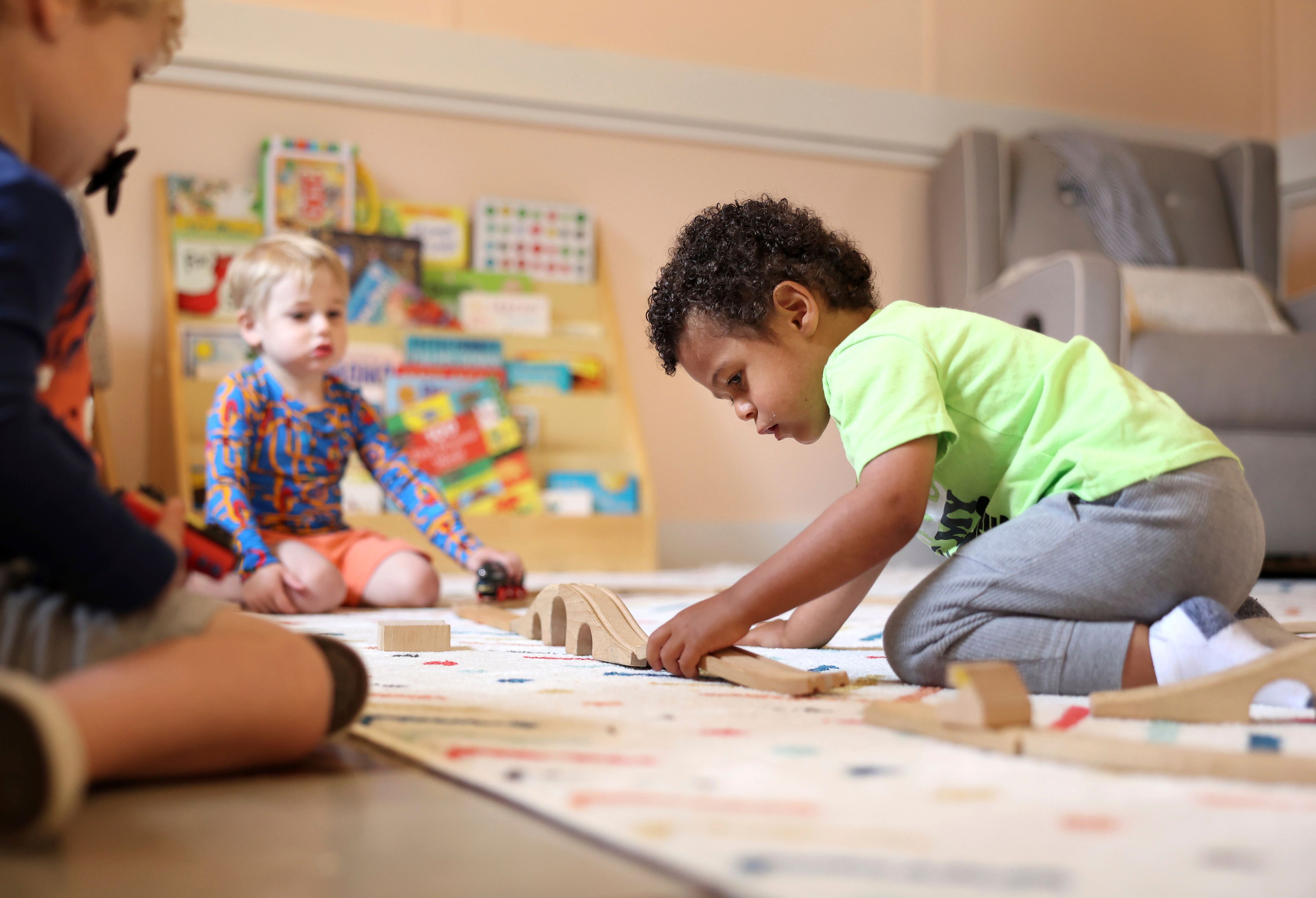 Elijah Rollings, 2, plays with a train set at Bumble Art Studio day care center in Astoria, Ore., Friday, Sept. 2, 2022. From Oregon to New York, demand for child care far exceeds supply. Families are growing increasingly desperate as providers deal with staffing shortages exacerbated by the coronavirus pandemic as well as historically low pay worsened by inflation. (AP Photo/Craig Mitchelldyer)