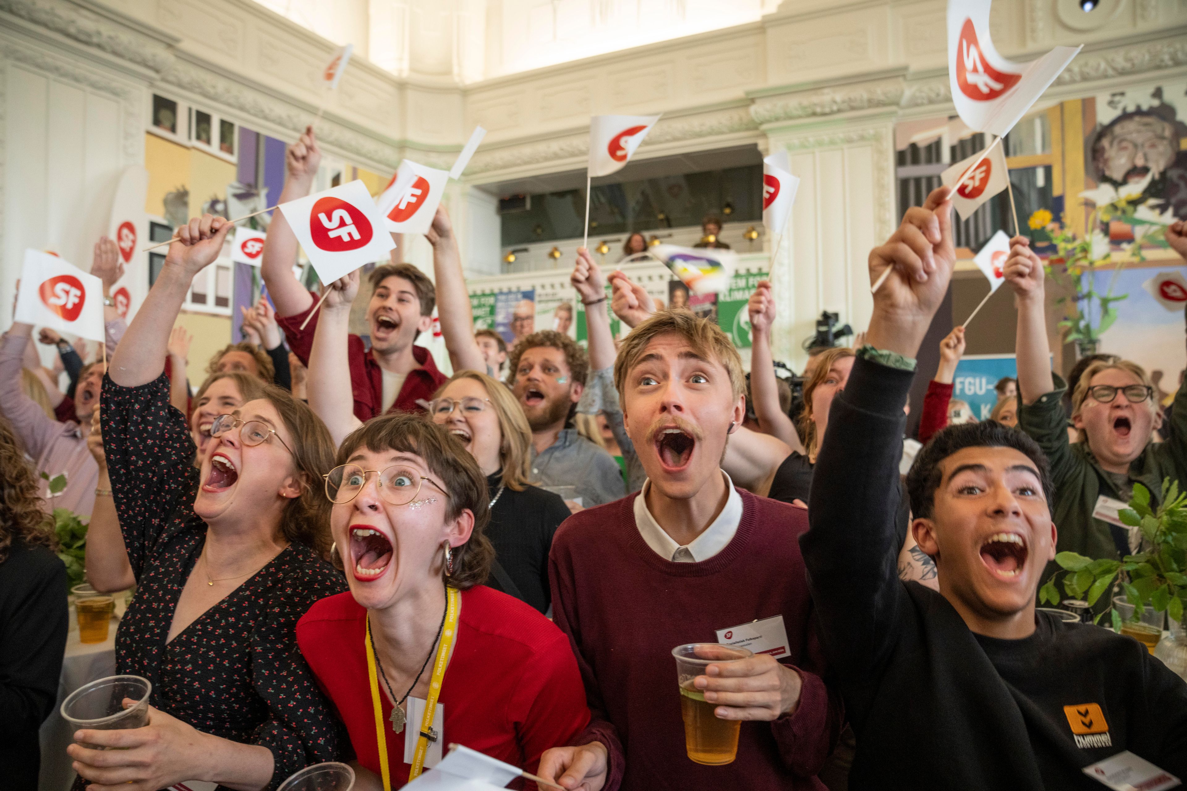 People cheer at the first exit poll at the Socialist People's Party for the election to the European Parliament at Christiansborg in Copenhagen, Sunday, June 9, 2024.