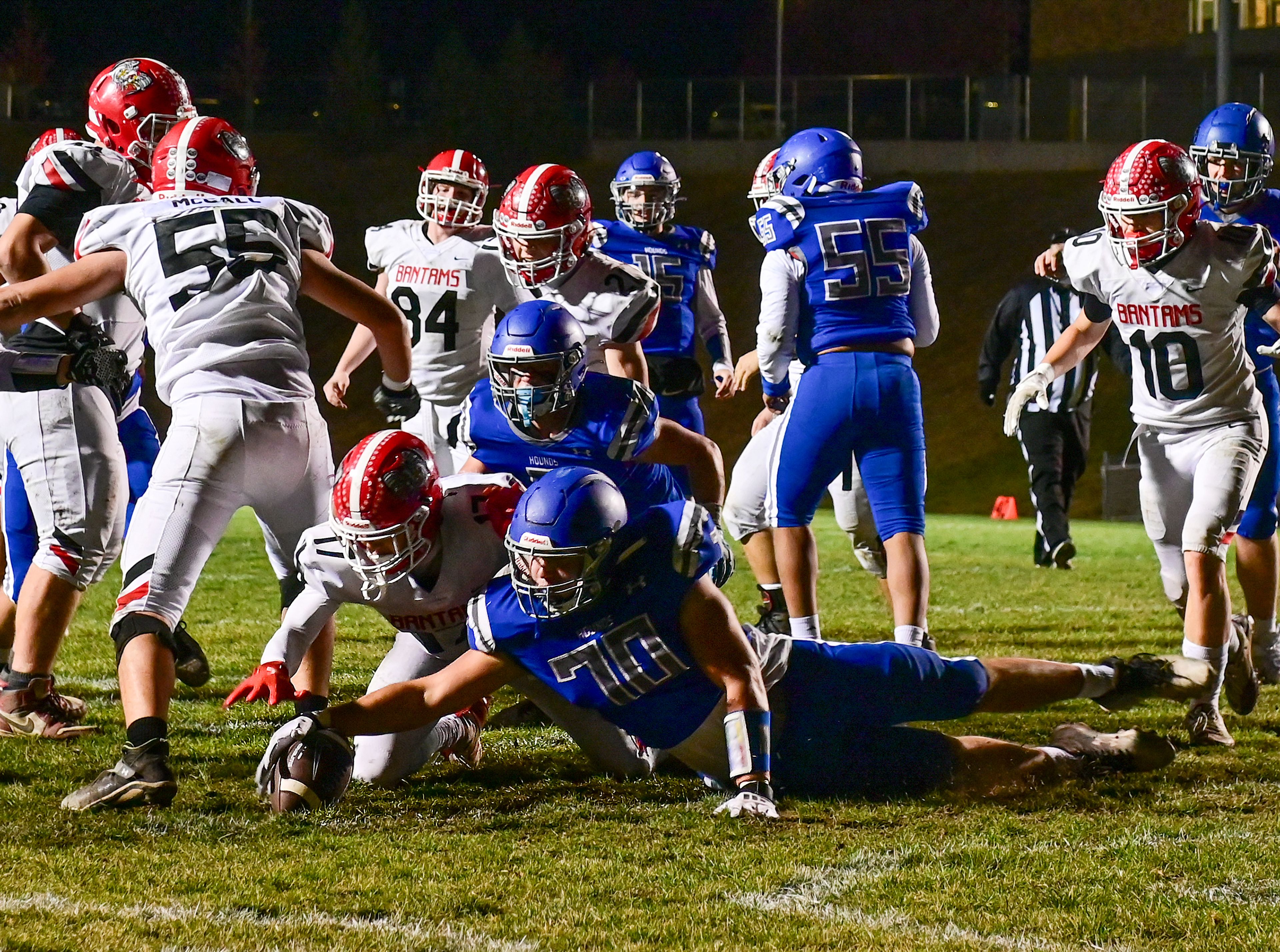 Clarkstons Ryken Craber and Pullmans Samuel Sears dive for control of the ball in the Greyhounds end zone Friday in Pullman.,