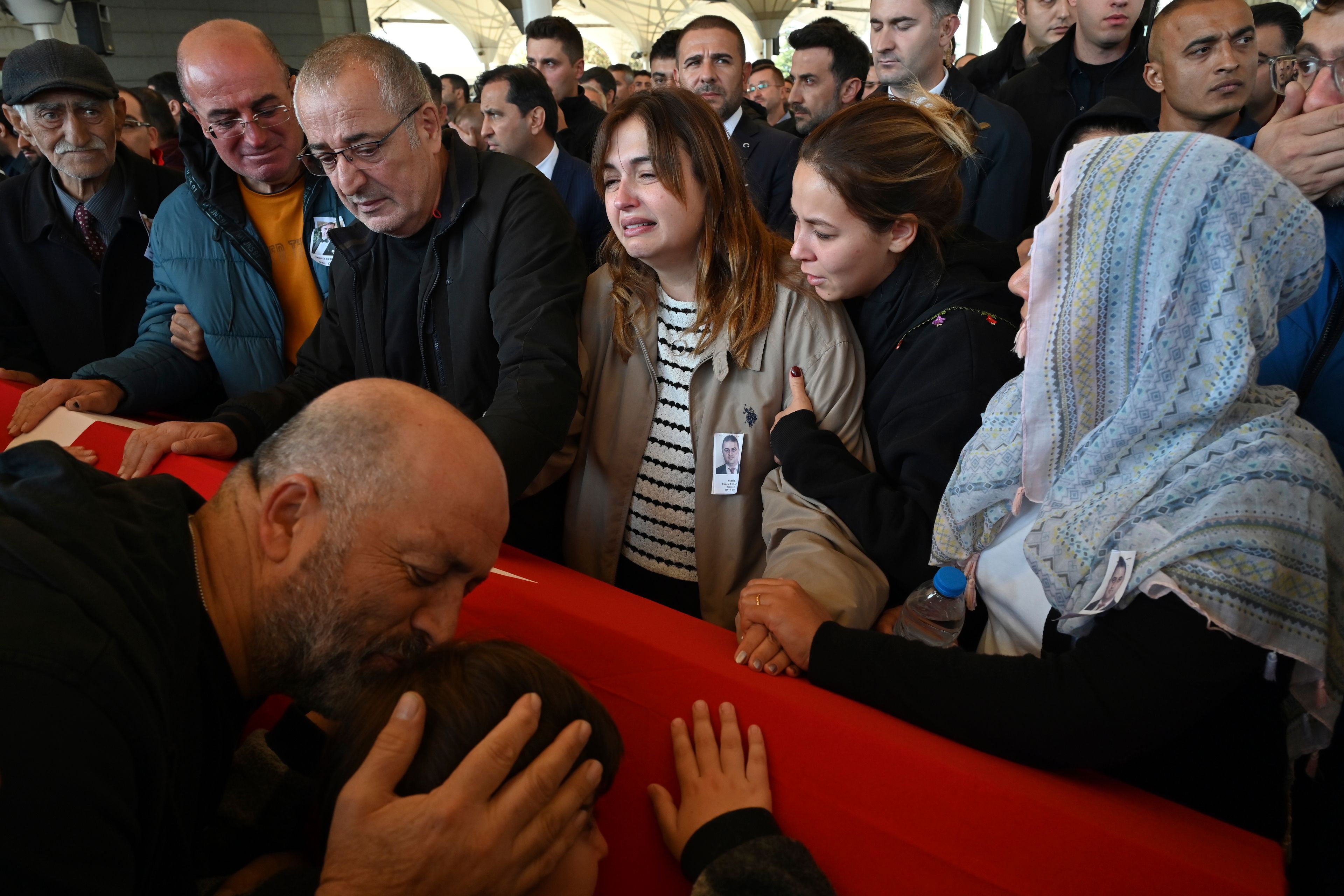 Relatives of Cengiz Coskun, who was killed during an attack by PKK members at the Turkish aerospace and defense company TUSAS on Wednesday, mourn during a funeral at Karsiyaka mosque in Ankara, Thursday, Oct. 24, 2024. (AP Photo/Ali Unal)