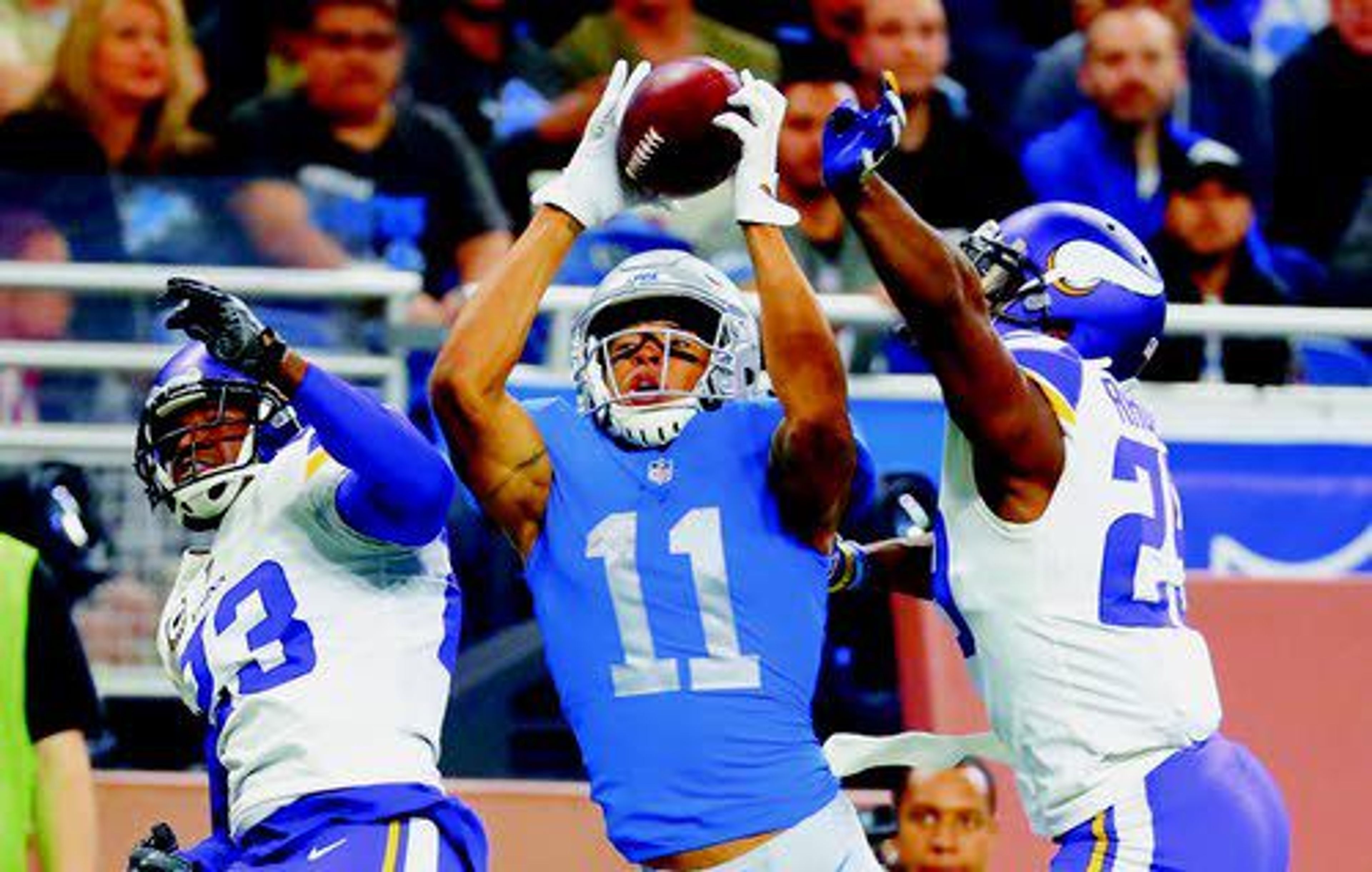 Detroit wide receiver Marvin Jones (center), guarded by Minnesota Vikings cornerbacks Terence Newman (23) and Xavier Rhodes (29), catches a 43-yard pass for a touchdown during the second half Thursday. Despite that TD, the Vikings held on for a 30-23 win at Detroit.