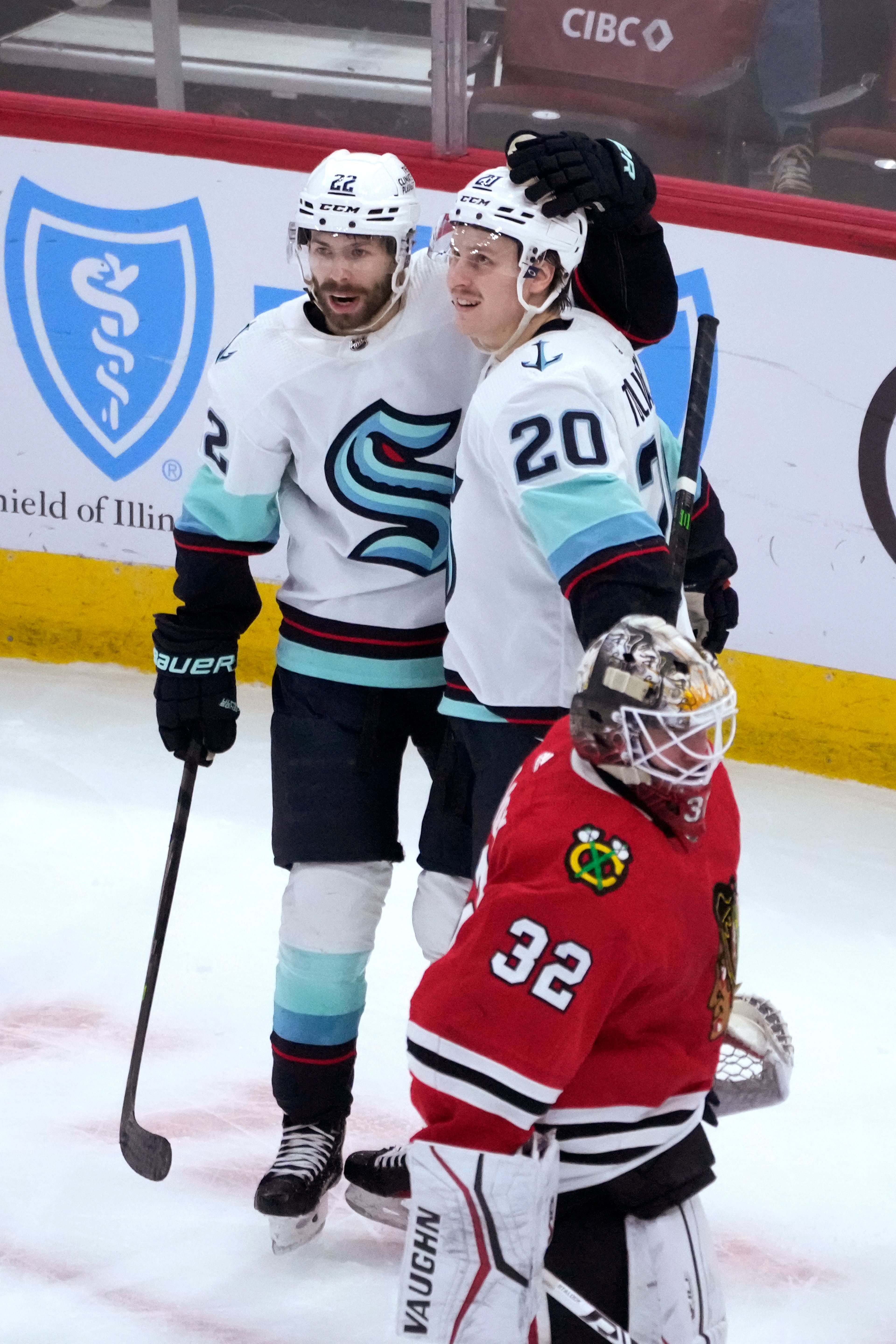 Seattle Kraken's Eeli Tolvanen (20) celebrates his goal with Oliver Bjorkstrand as Chicago Blackhawks goaltender Alex Stalock returns to the net during the first period of an NHL hockey game Saturday, Jan. 14, 2023, in Chicago. (AP Photo/Charles Rex Arbogast)