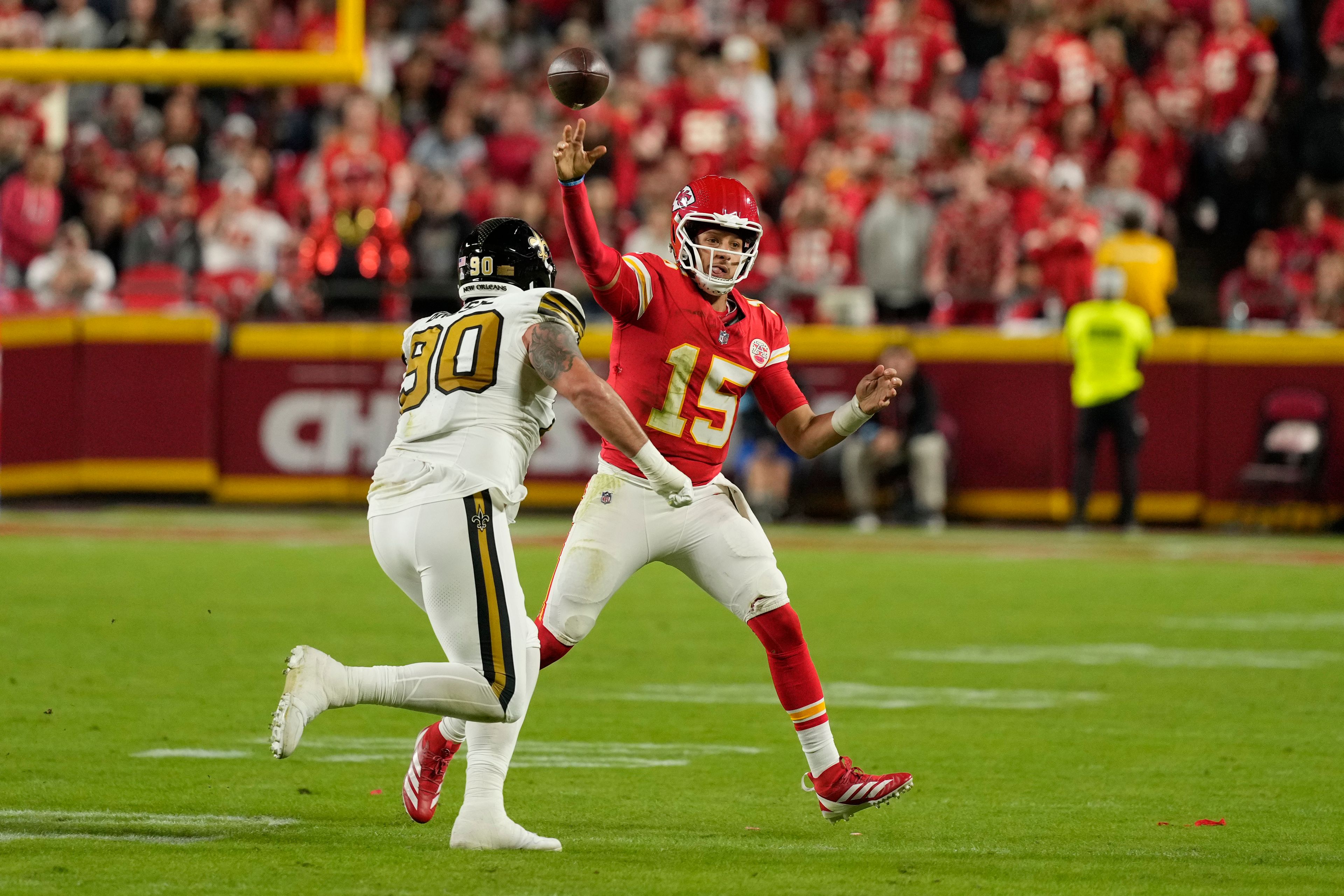 Kansas City Chiefs quarterback Patrick Mahomes (15) throws over New Orleans Saints defensive tackle Bryan Bresee (90) during the first half of an NFL football game Monday, Oct. 7, 2024, in Kansas City, Mo. (AP Photo/Charlie Riedel)