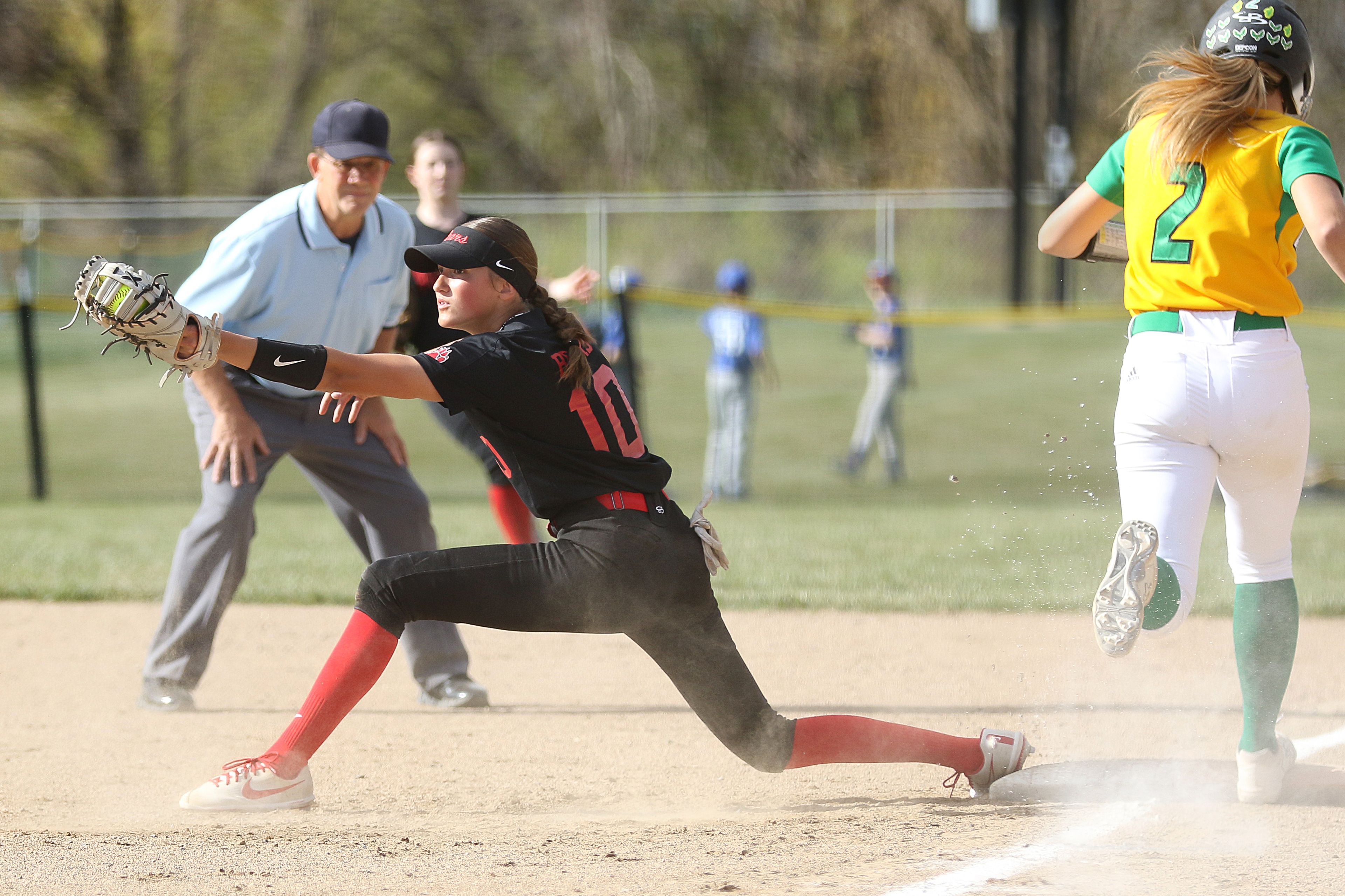 Moscow first baseman Kaci Kiblen (10) receives a throw to get the out at first base during an Idaho Class 4A district championship game against Lakeland on Thursday in Moscow.