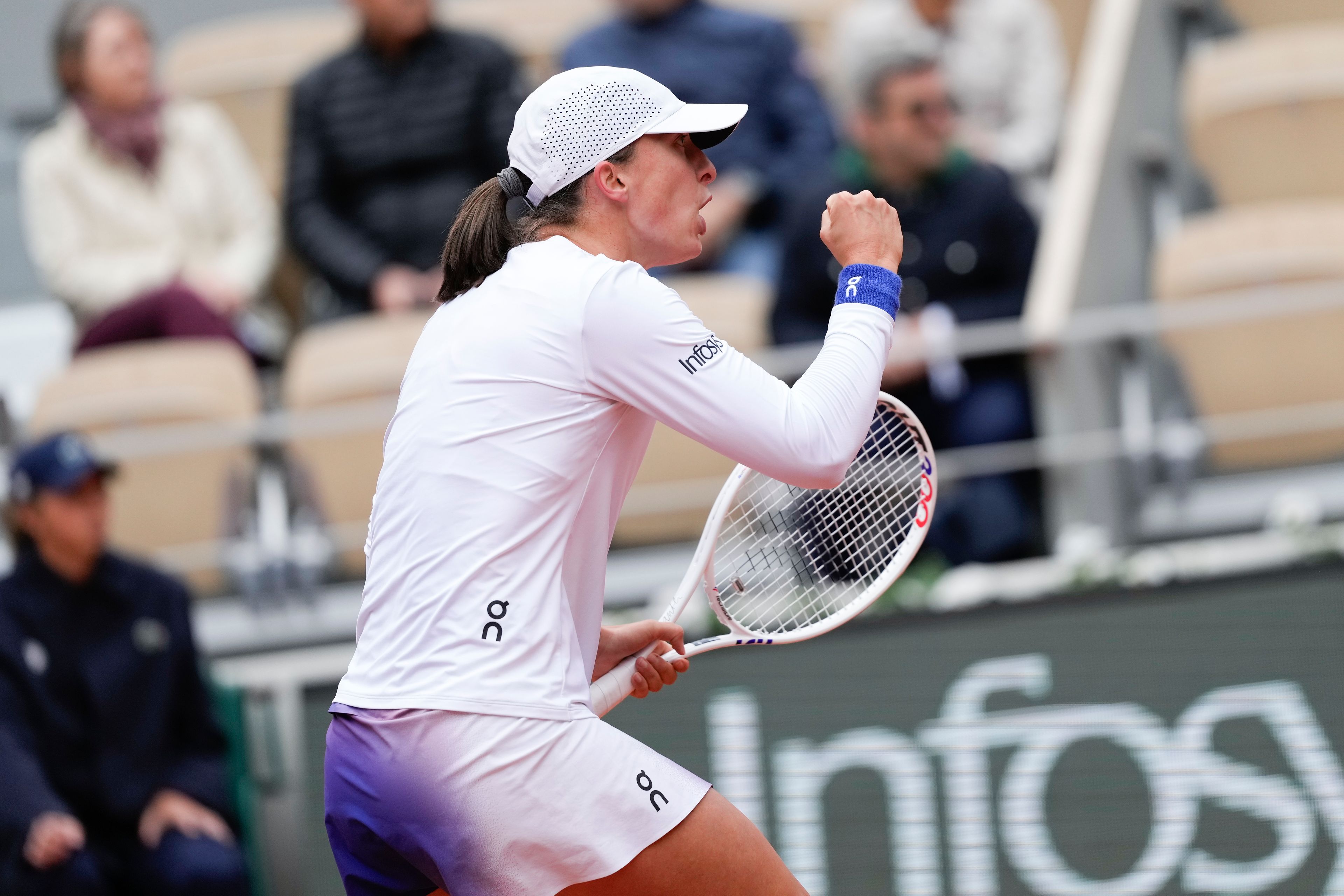 Poland's Iga Swiatek clenches her fist after scoring a point against Russia's Anastasia Potapova during their fourth round match of the French Open tennis tournament at the Roland Garros stadium in Paris, Sunday, June 2, 2024.