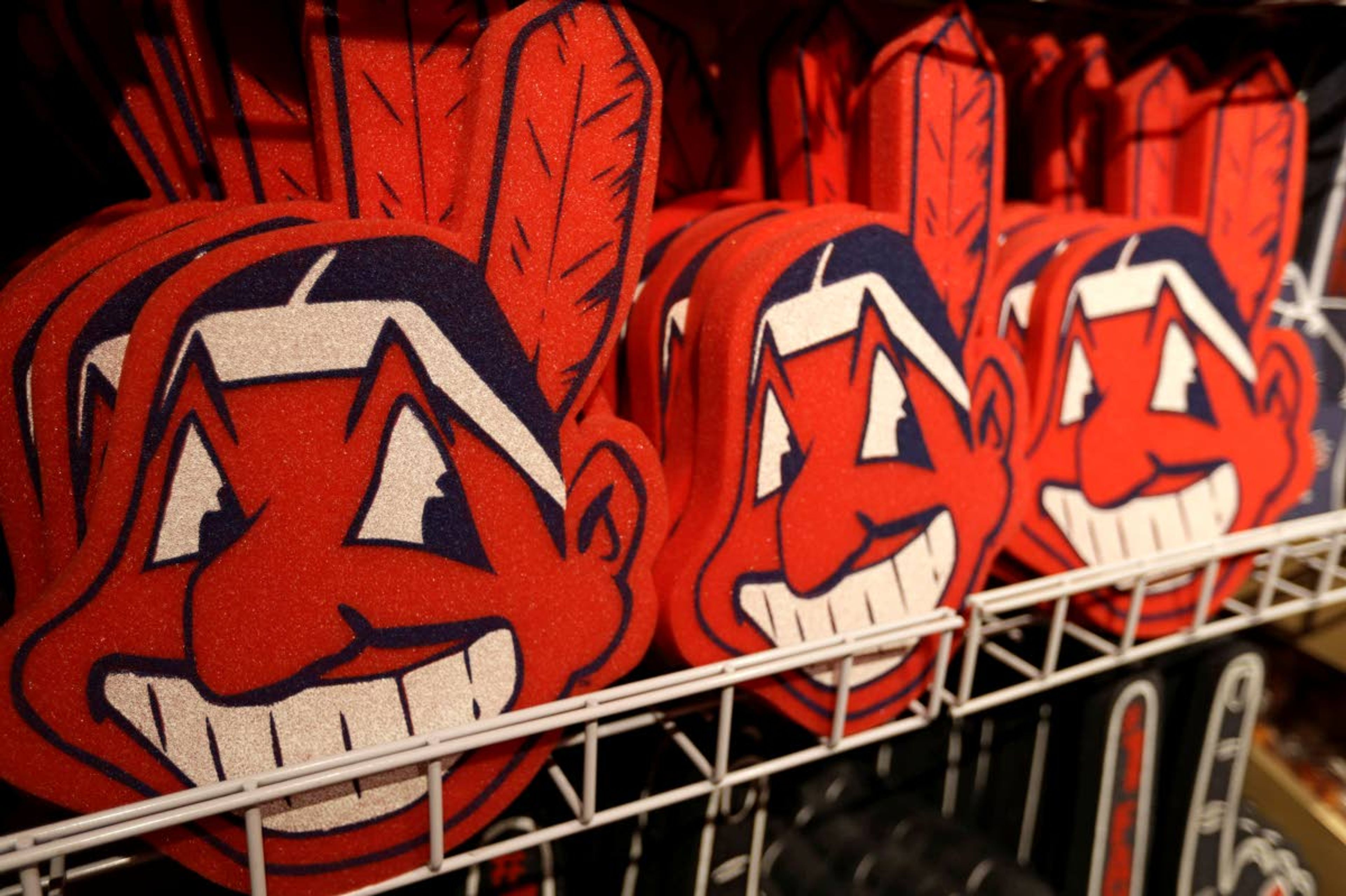 FILE - In this Jan. 29, 2018 file photo, foam images of the MLB baseball Cleveland Indians' mascot Chief Wahoo are displayed for sale at the Indians' team shop in Cleveland. The Chief Wahoo logo is being removed from the Cleveland Indians' uniform in the 2019 season, but the Club will still sell merchandise featuring the mascot in Northeast Ohio. The U.S. has spent most of 2019 coming to grips with blackface and racist imagery, but Native Americans say they don't see significant pressure applied to those who perpetuate Native American stereotypes. (AP Photo/Tony Dejak, File)