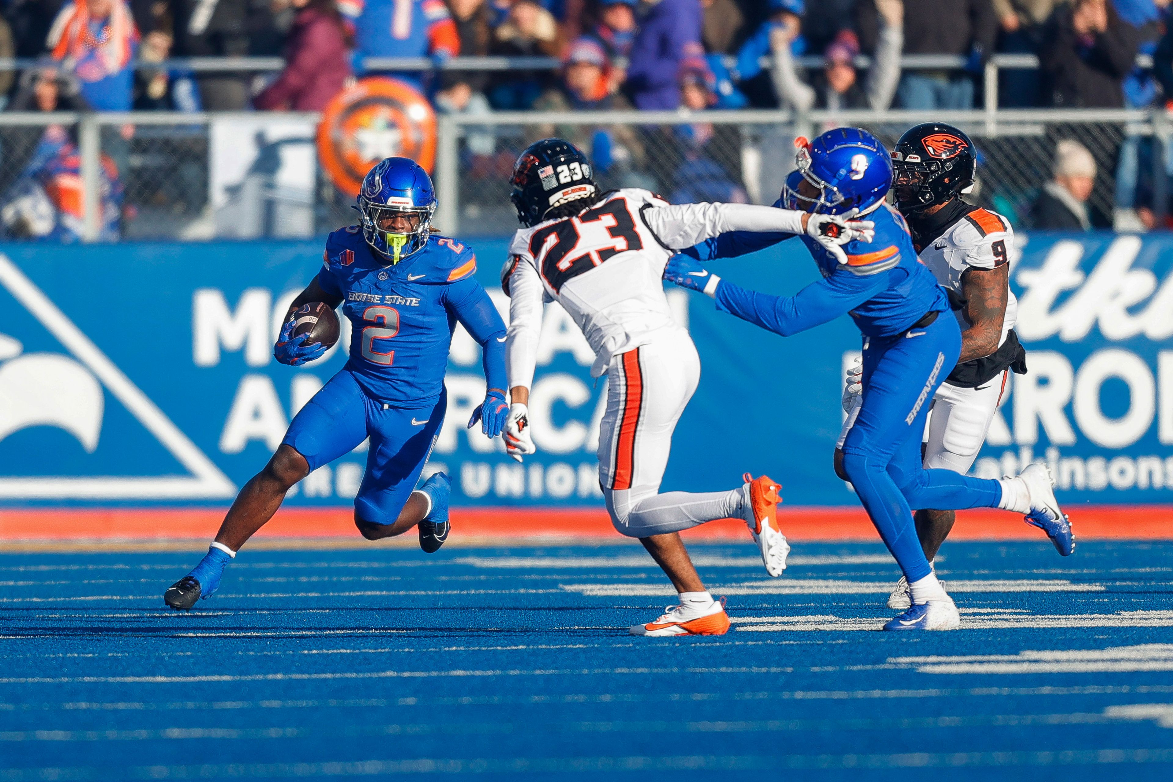 Boise State running back Ashton Jeanty (2) runs with the ball as wide receiver Cameron Camper (9) blocks Oregon State defensive back Exodus Ayers (23) in the first half of an NCAA college football game, Friday, Nov. 29, 2024, in Boise, Idaho. (AP Photo/Steve Conner)