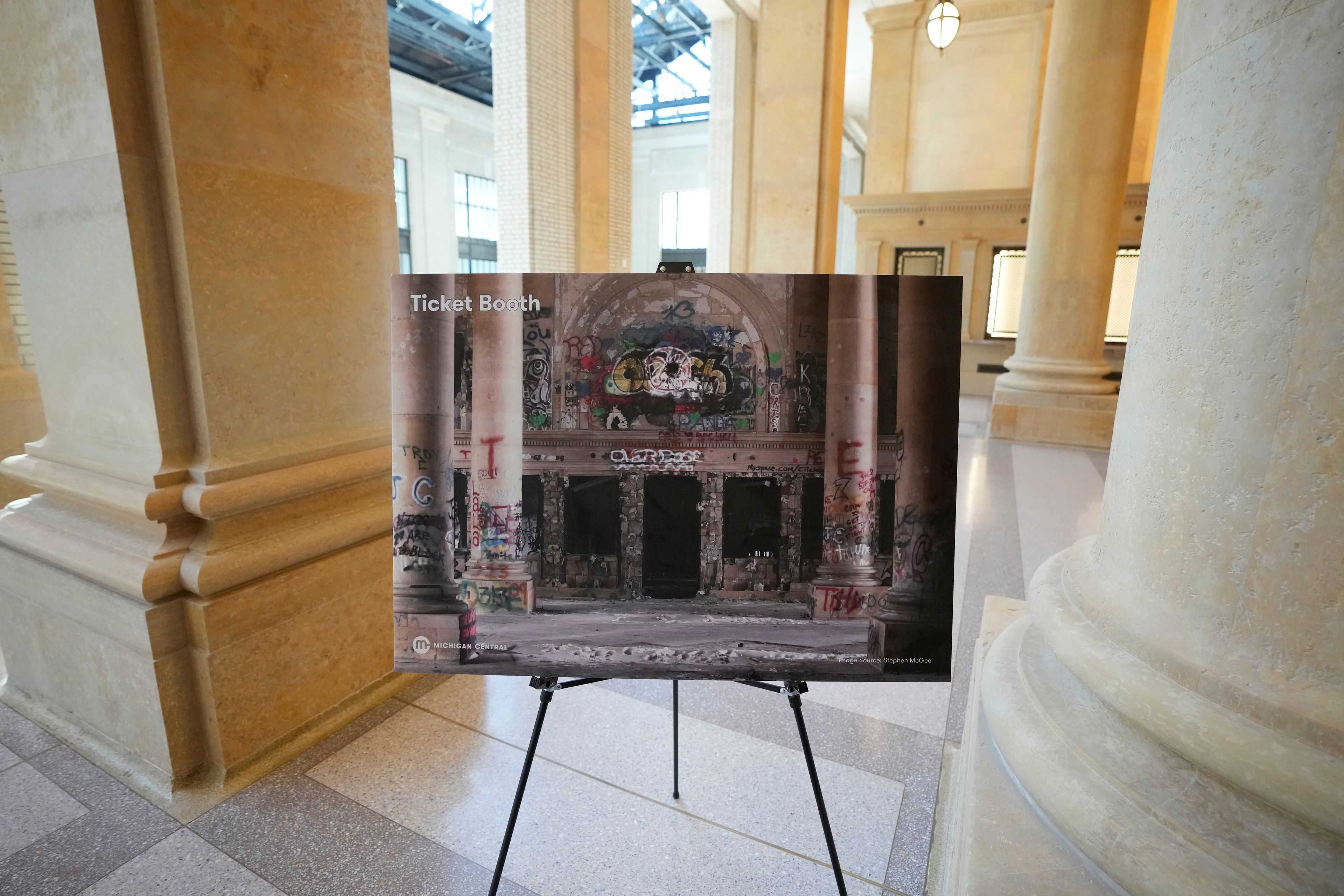 A photograph showing the scavenger-ravaged ticket booth area is displayed at the Michigan Central Station, Monday, May 13, 2024 in Detroit. A once hulking scavenger-ravaged monolith that symbolized Detroit's decline reopens this week after a massive six-year multimillion dollar renovation by Ford Motor Co., which restored the Michigan Central Station to its past grandeur with a focus squarely on the future of mobility.