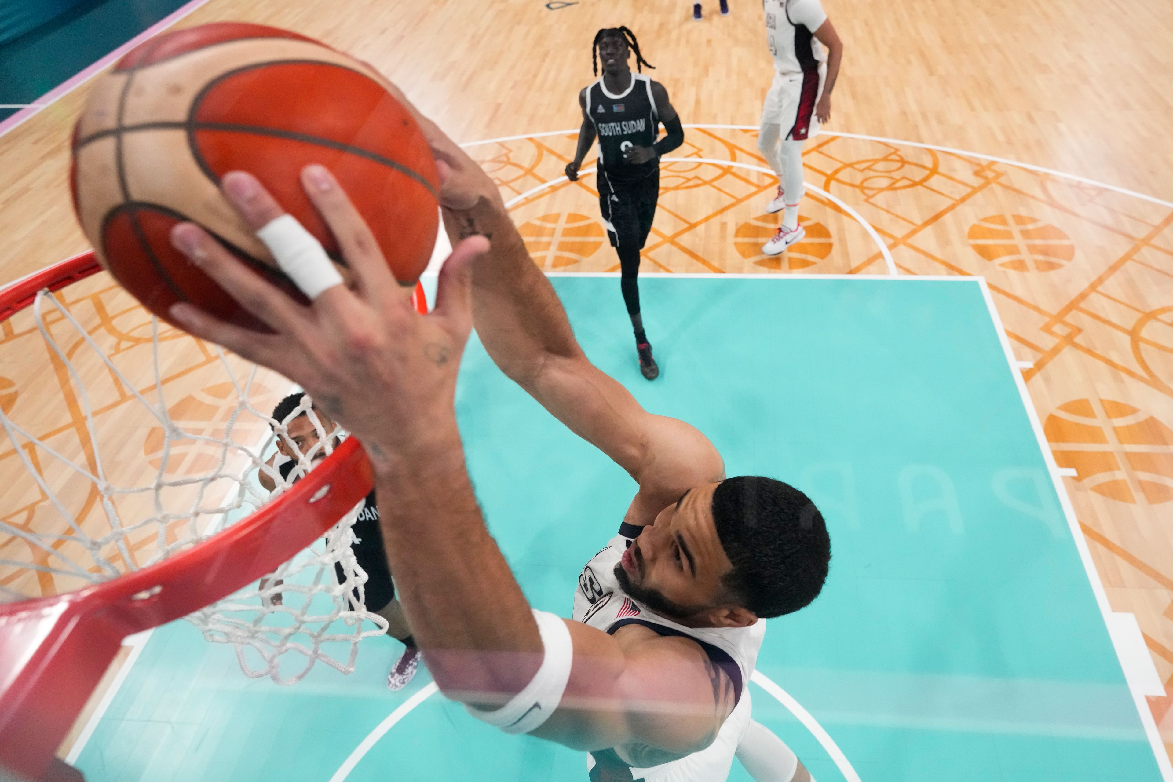 Jayson Tatum, of the United States, gets a basket on a dunk against South Sudan in a men's basketball game at the 2024 Summer Olympics, Wednesday, July 31, 2024, in Villeneuve-d'Ascq, France. (AP Photo/Mark J. Terrill, Pool)