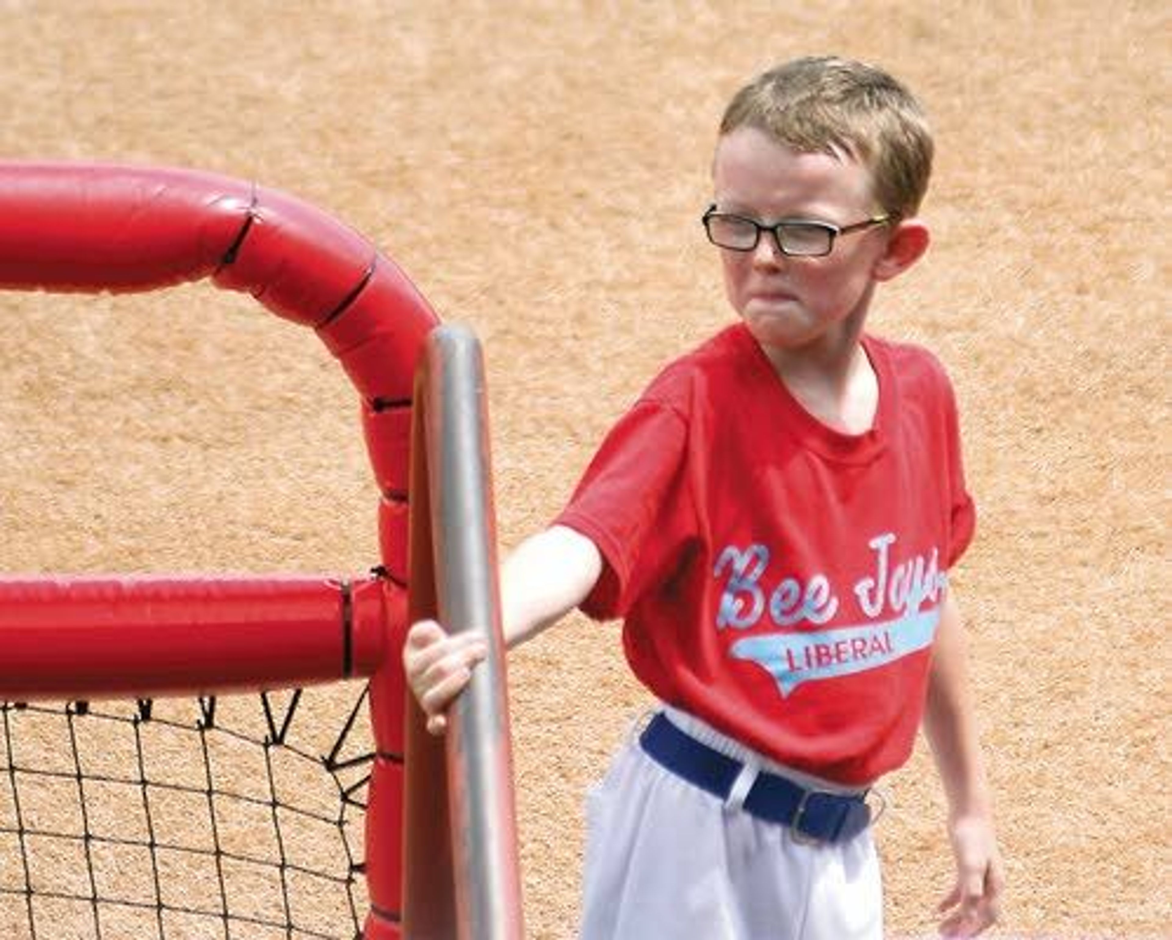 This photo taken Saturday shows Liberal Bee Jays batboy Kaiser Carlile, 9, as he gets ready for a game at the National Baseball Congress World Series in Wichita, Kan. Carlile was accidentally hit in the head during the game by a follow-through swing near the on-deck circle. He died on Sunday.