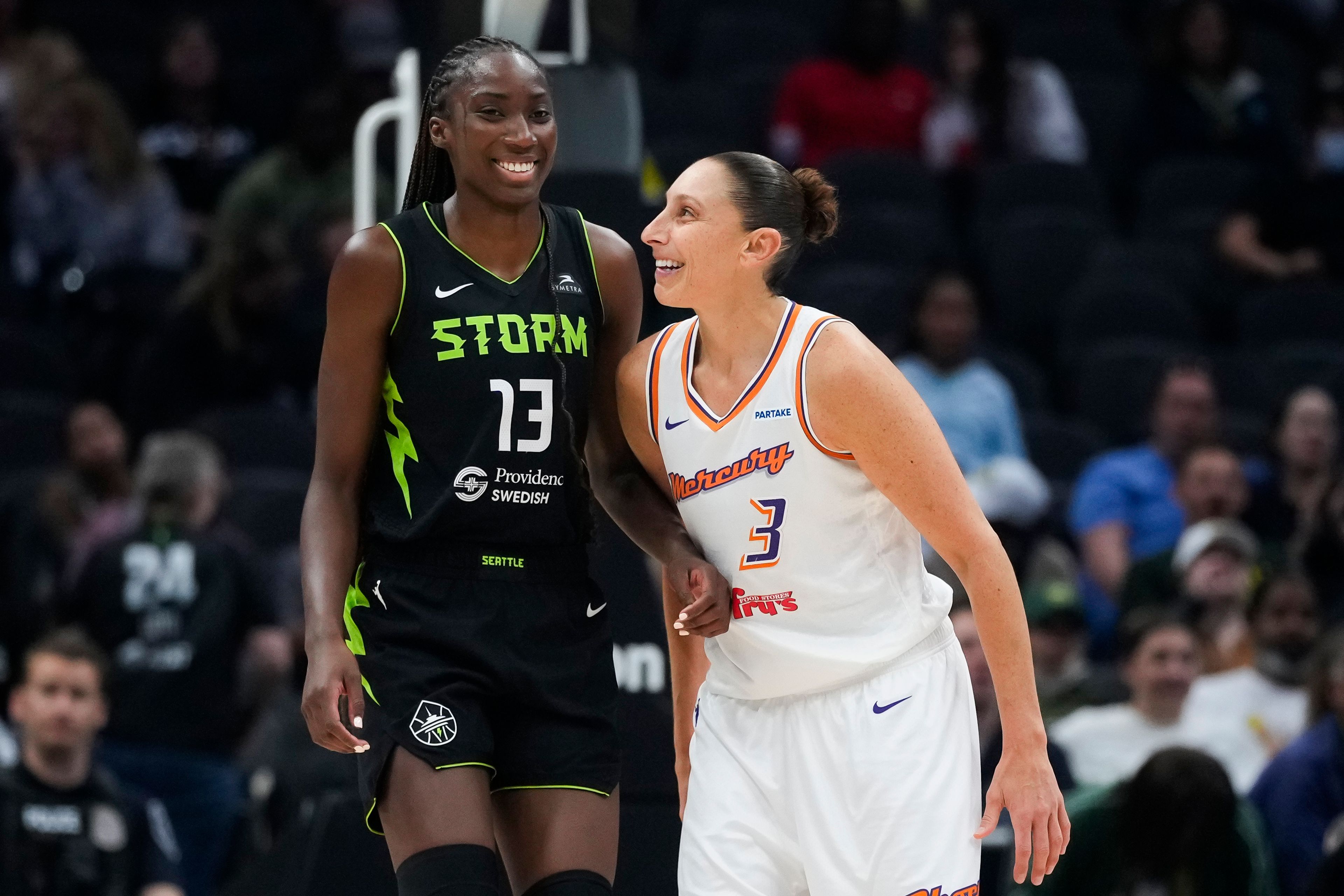 Seattle Storm center Ezi Magbegor (13) and Phoenix Mercury guard Diana Taurasi (3) smile during a stoppage in play during the second half of a WNBA basketball game Tuesday, June 4, 2024, in Seattle. The Storm won 80-62.