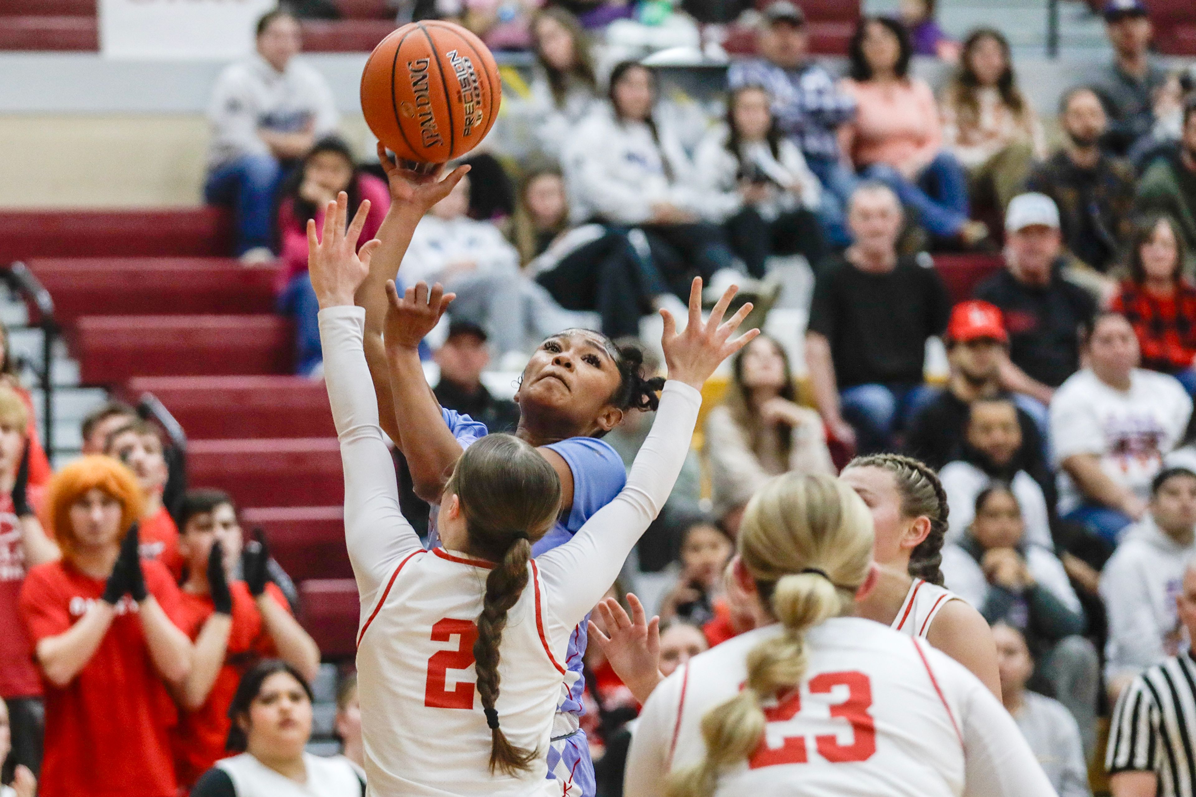 Lapwai's Samara Powaukee shoots the ball over Oakley point guard Jentry Hawker during an Idaho Class 1A DI girls state semifinal game Friday at Columbia High School.