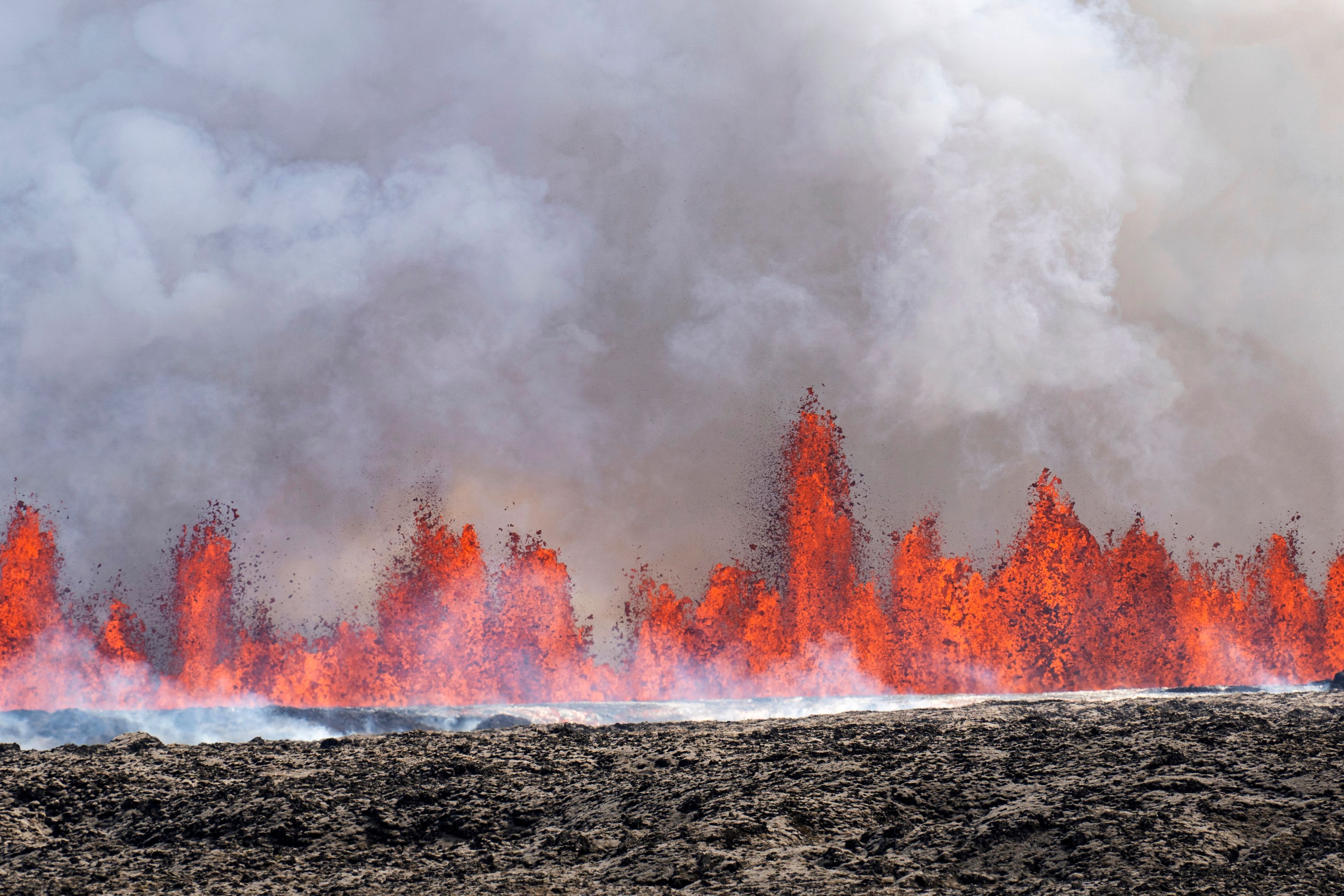 A volcano spews lava in Grindavik, Iceland, Wednesday, May 29, 2024. A volcano in southwestern Iceland is erupting, spewing red streams of lava in its latest display of nature's power. A series of earthquakes before the eruption Wednesday triggered the evacuation of the popular Blue Lagoon geothermal spa. The eruption began in the early afternoon north of Grindavik, a coastal town of 3,800 people that was also evacuated.