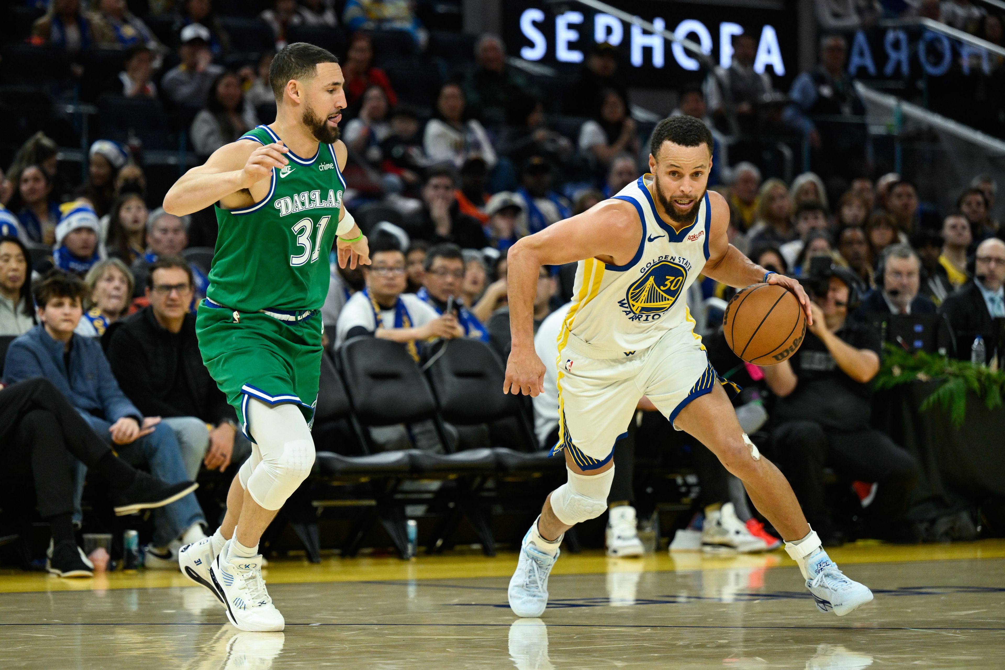 Warriors guard Stephen Curry dribbles against Mavericks guard Klay Thompson (31) during a game Thursday in San Francisco.