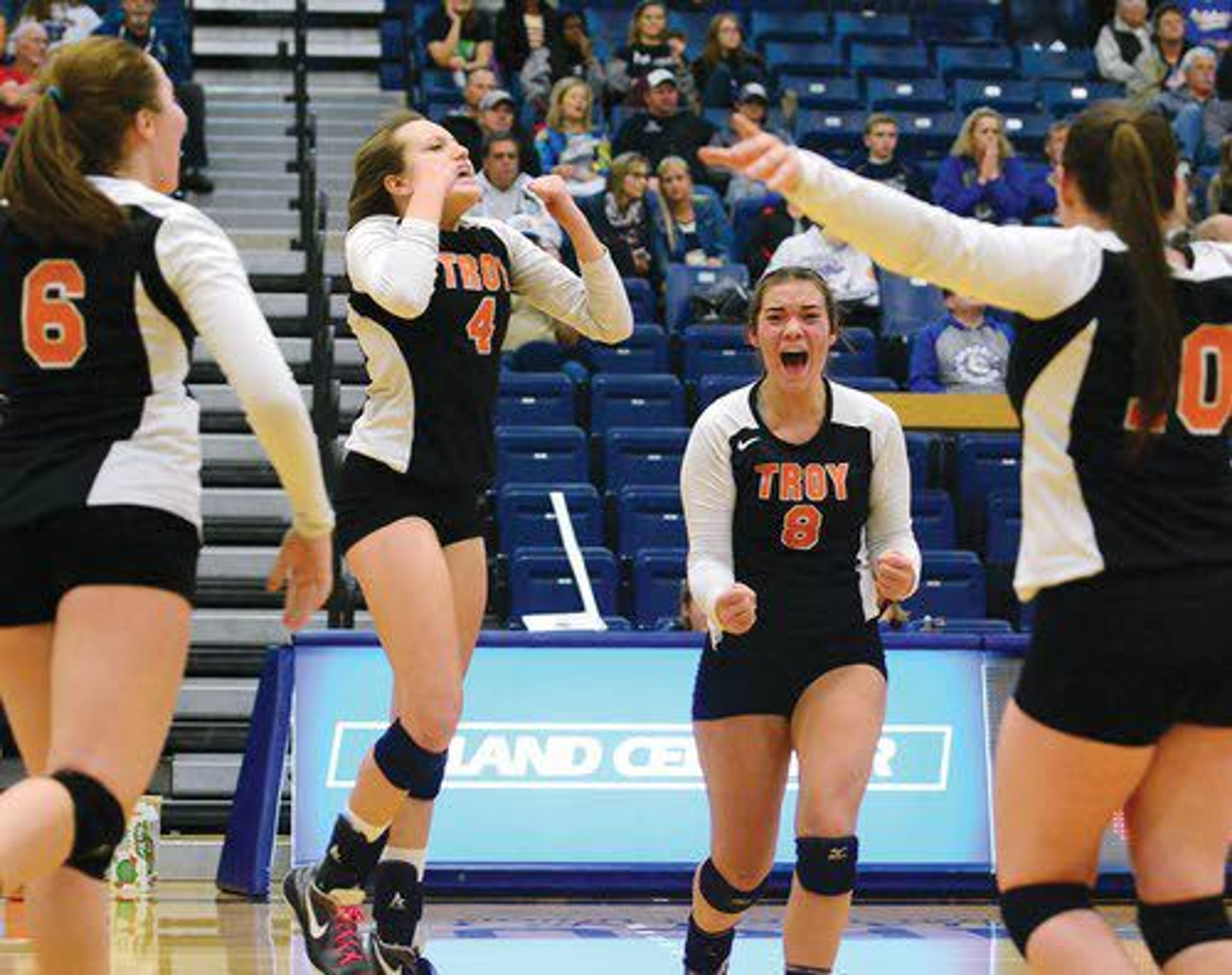 Troy players celebrate after scoring a point late in the fourth set of the Class 1A Division 1 District II Championship Game against Genesee on Tuesday night at the Lewis Clark State College Activity Center in Lewiston. Troy defeated Genesee, 3-1.