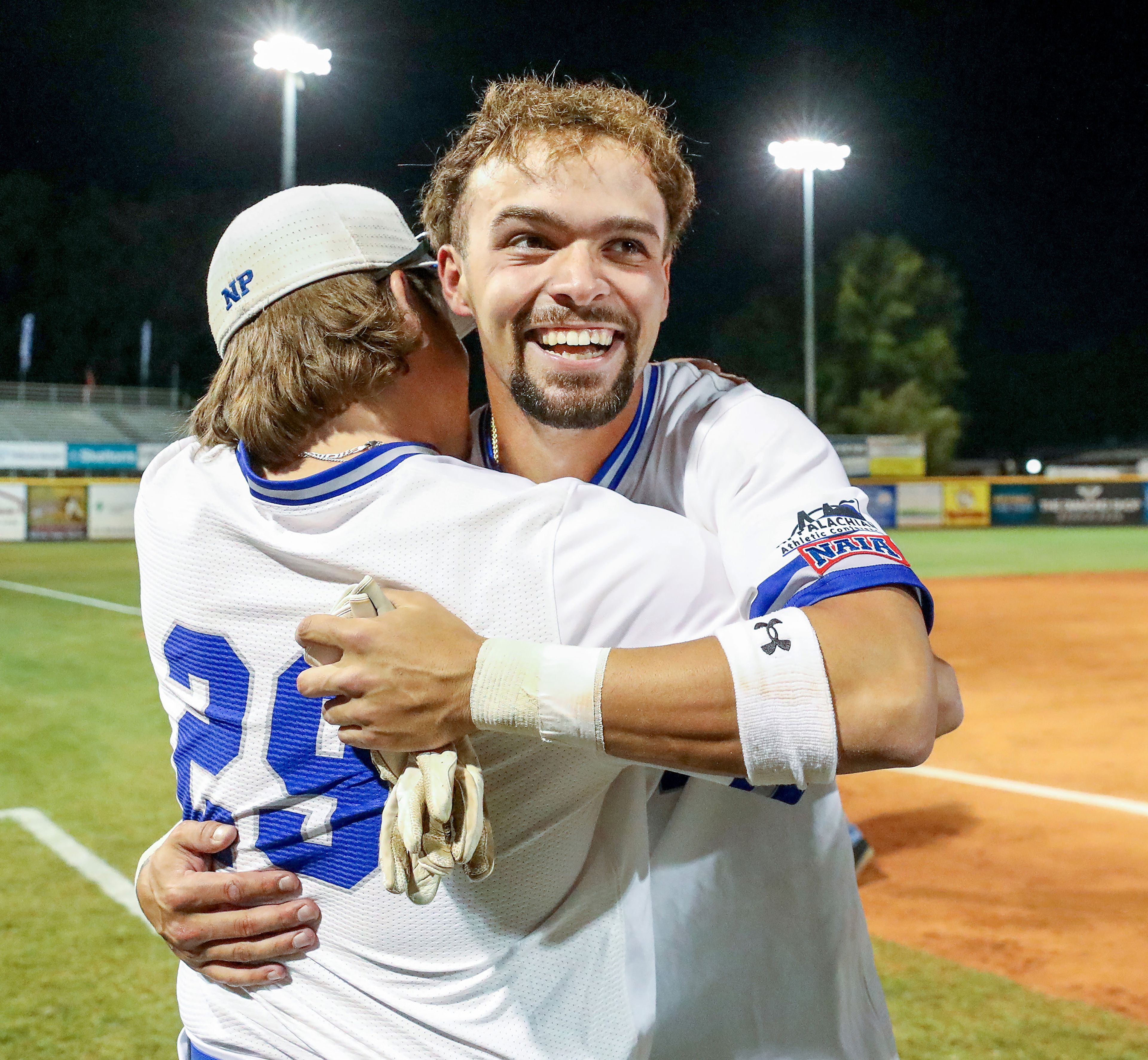 Tennessee Wesleyan’s Cade Bochlter embraces Kruise Newman after the team’s win over Reinhardt in Game 18 of the NAIA World Series at Harris Field in Lewiston on Thursday.