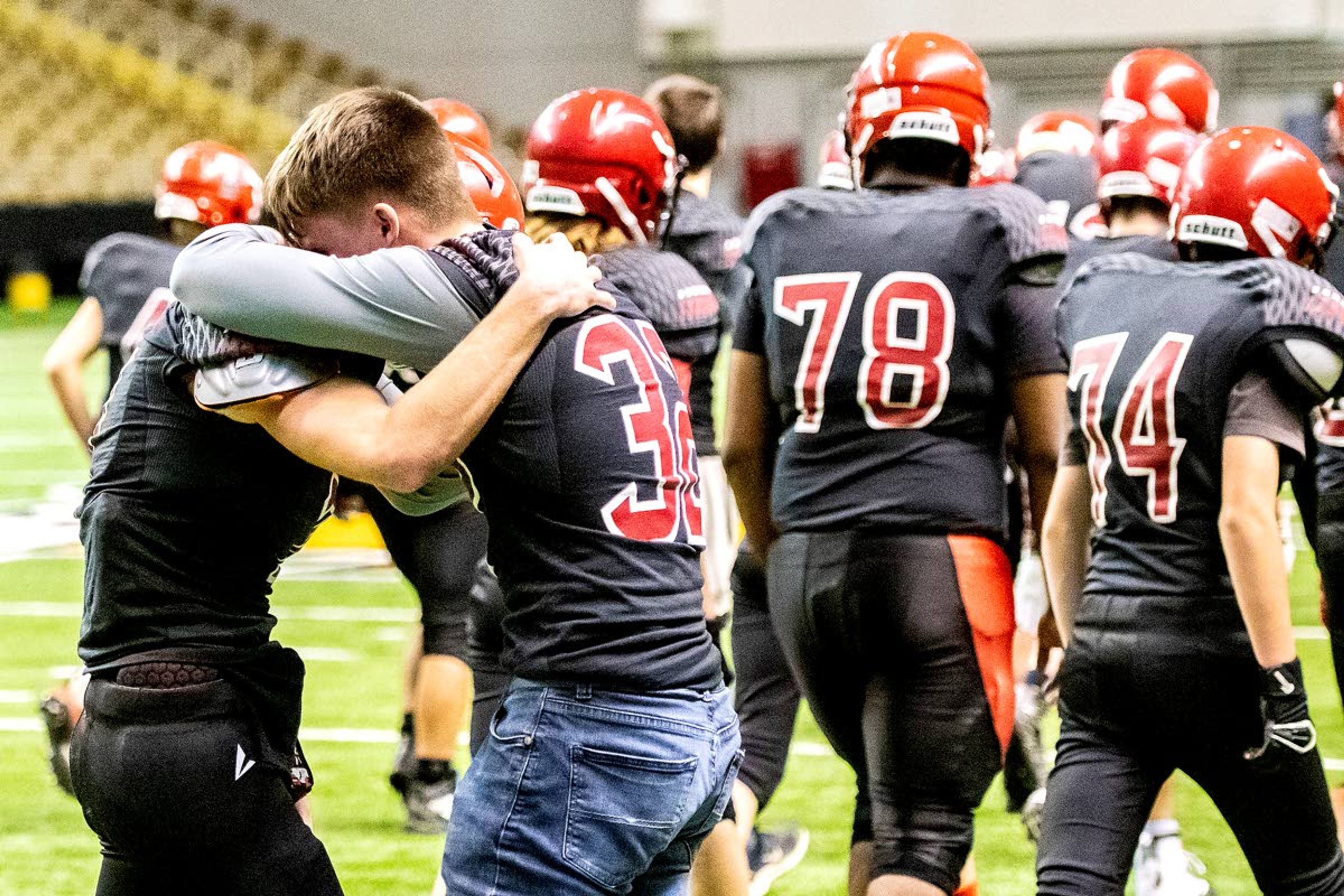 Injured Prairie senior running back Cole Martin embraces Prairie senior quarterback Cole Schlader after the Pirates fell to Oakley 42-40 in a Class 1A Division I state semifinal round game Friday at the University of Idaho’s Kibbie Dome.