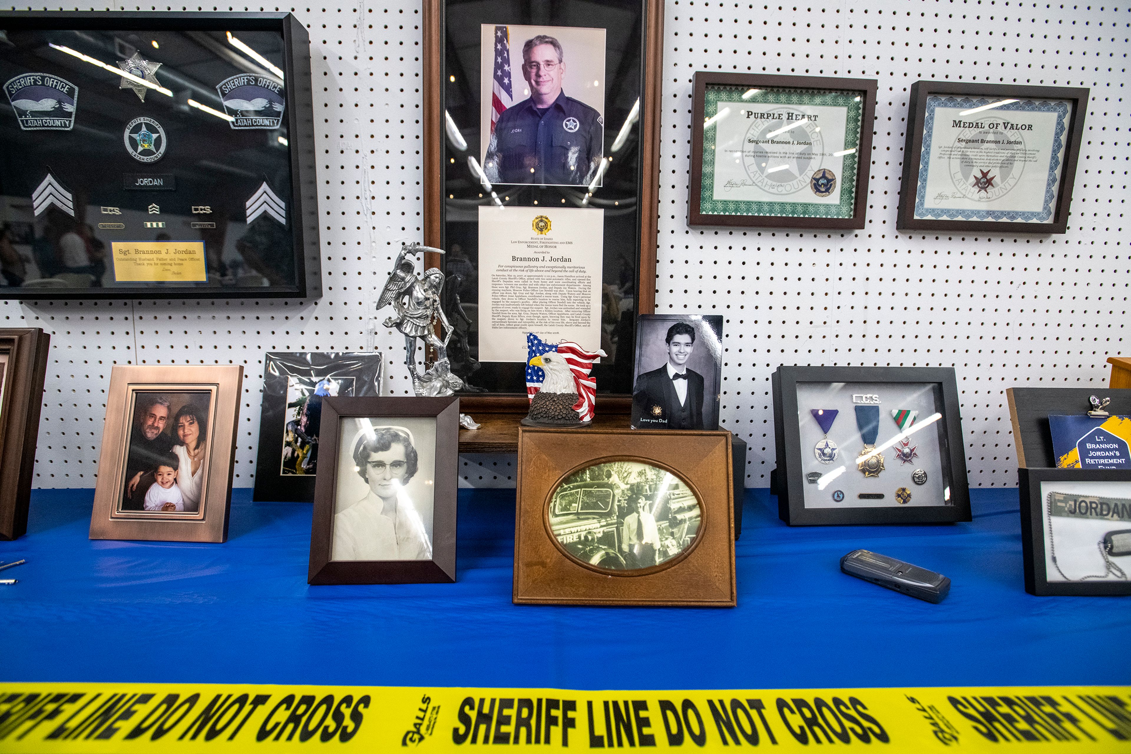 Memorabilia including photographs and medals are displayed on a table Thursday during a party celebrating Lt. Brannon Jordan’s retirement from the Latah County Sheriff’s Office at the Latah County Fair Office in Moscow.