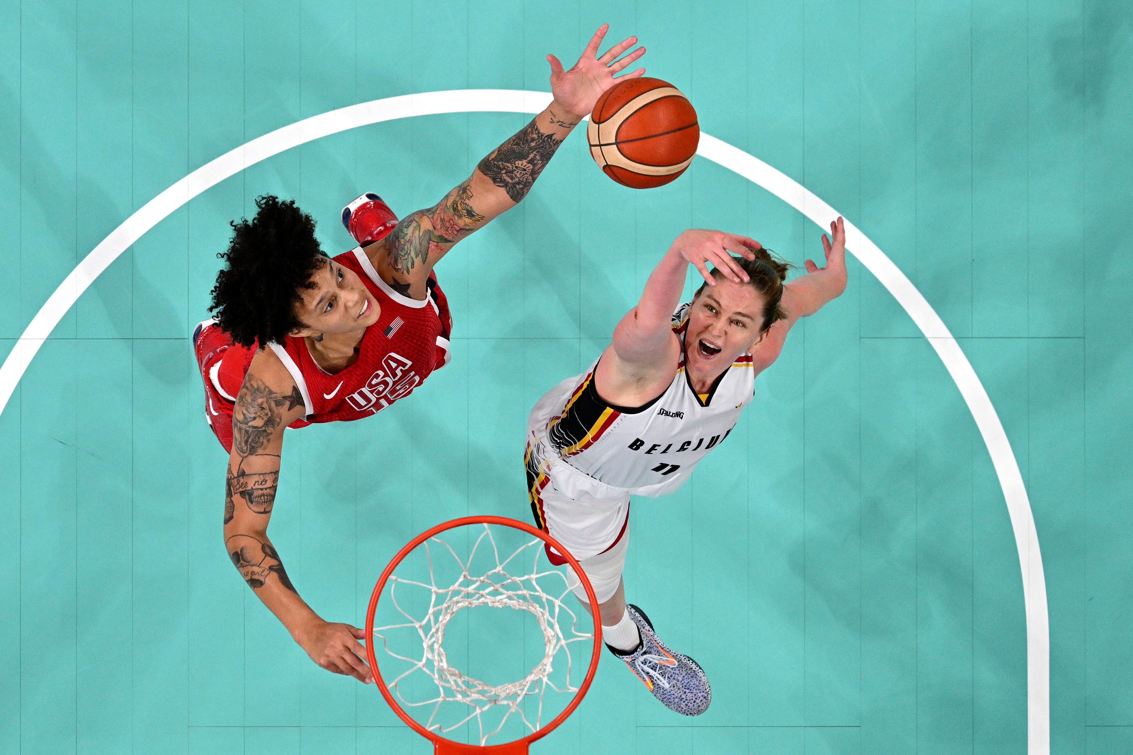 United States' Brittney Griner, left, and Belgium's Emma Meesseman reach for a rebound in a women's basketball game at the 2024 Summer Olympics, Thursday, Aug. 1, 2024, in Villeneuve-d'Ascq, France. (Sameer Al-Doumy/Pool Photo via AP)