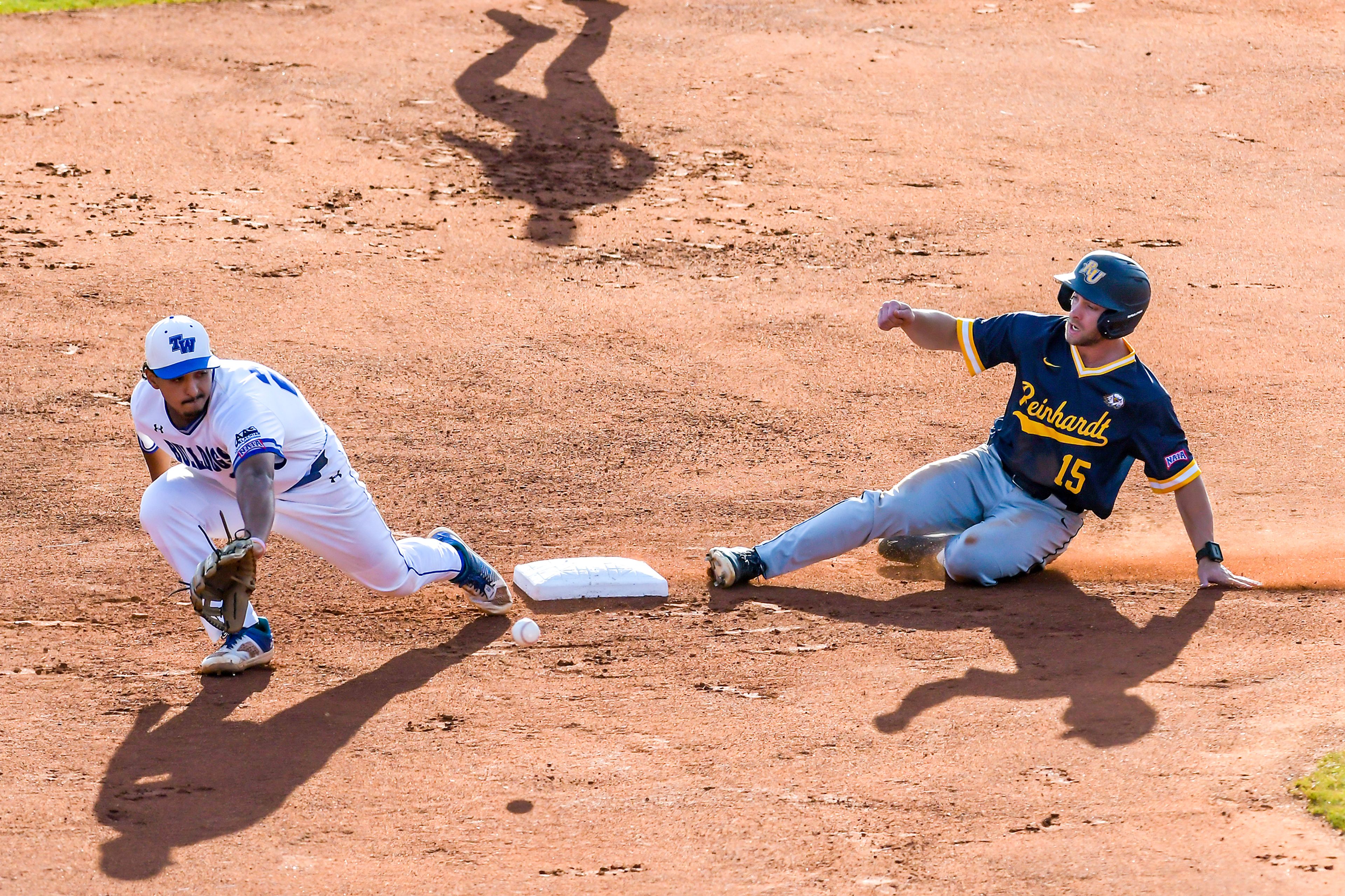 Reinhardt’s Lance Dockery slides safely into second base as Tennessee Wesleyan shortstop Marco Martinez reaches out to catch the ball in Game 18 of the NAIA World Series at Harris Field Thursday in Lewiston.