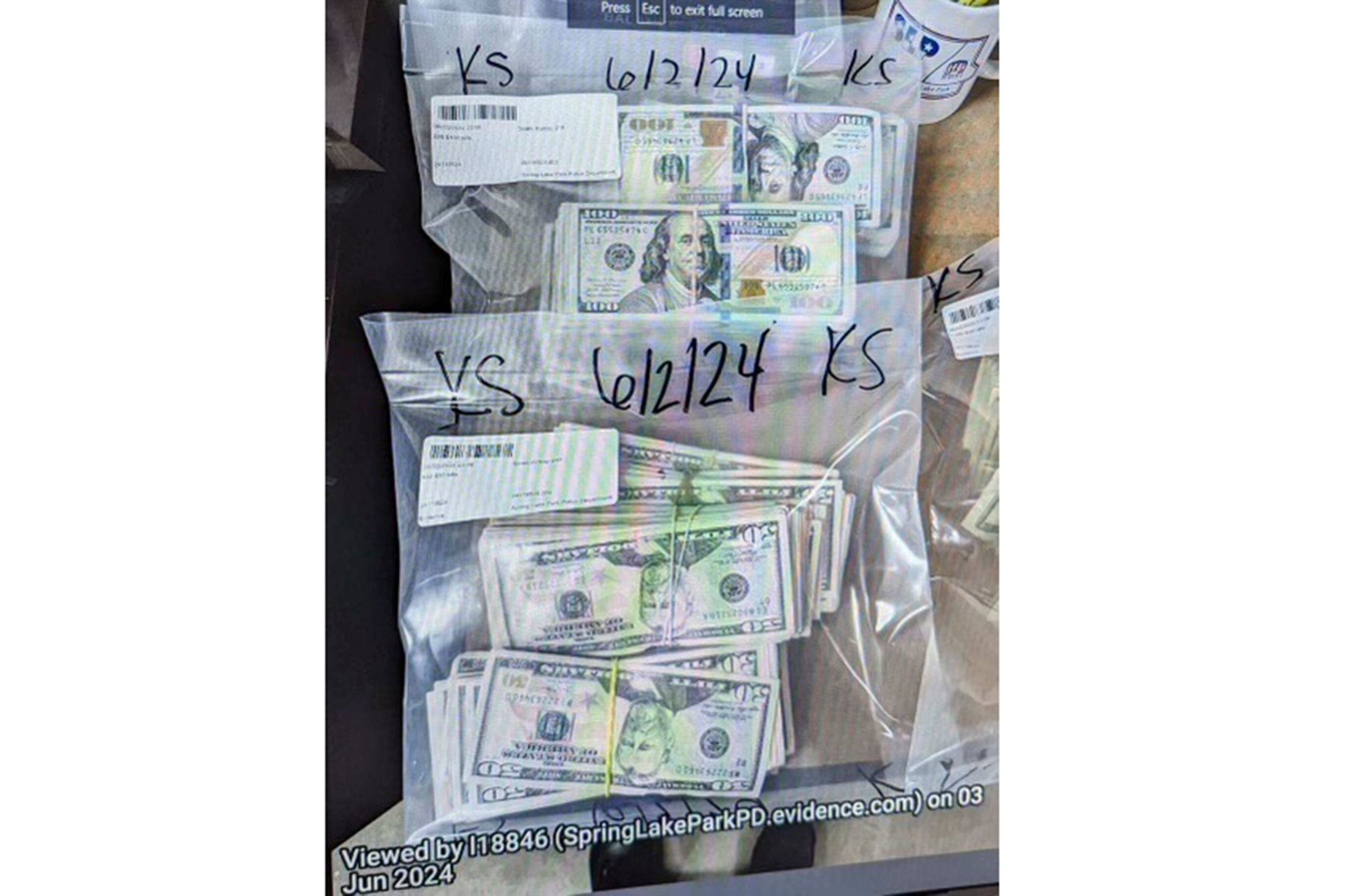 This photo supplied by the U.S. Attorney's Office for Minnesota shows cash from a bag that was left at the home of a juror in a massive fraud case, June 2, 2024, outside Minneapolis, Minn. Authorities have confiscated cellphones and taken all seven defendants into custody as investigators try to determine who attempted to bribe the juror to acquit them on charges of stealing more than $40 million from a program meant to feed children during the pandemic.