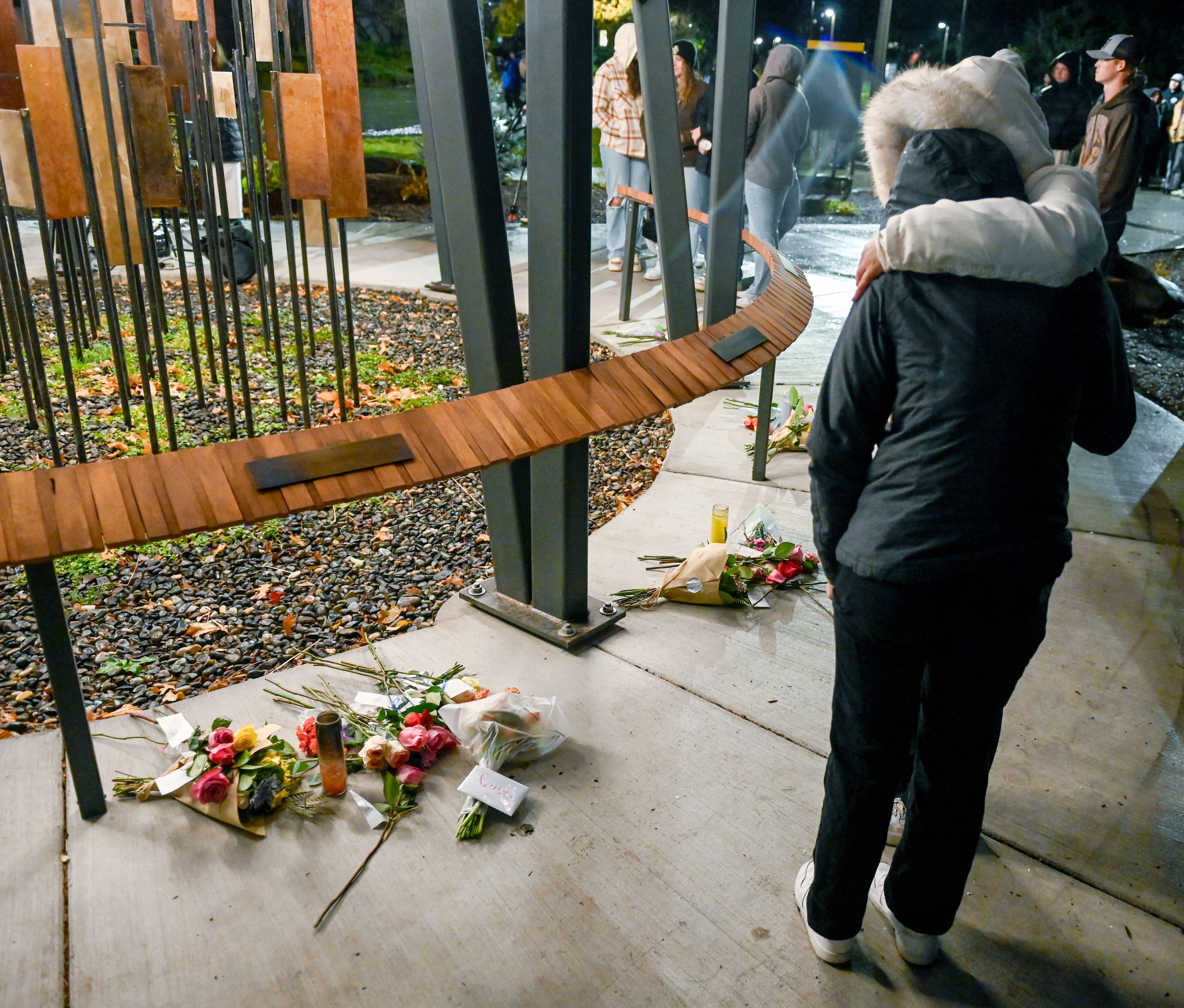 Two people embrace after placing flowers in front of Xana Kernodle’s plaque during a vigil at the Vandal Healing Garden and Memorial Wednesday in Moscow. A vigil was held for the four students murdered two years earlier—Kernodle, Madison Mogen, Kaylee Goncalves and Ethan Chapin.