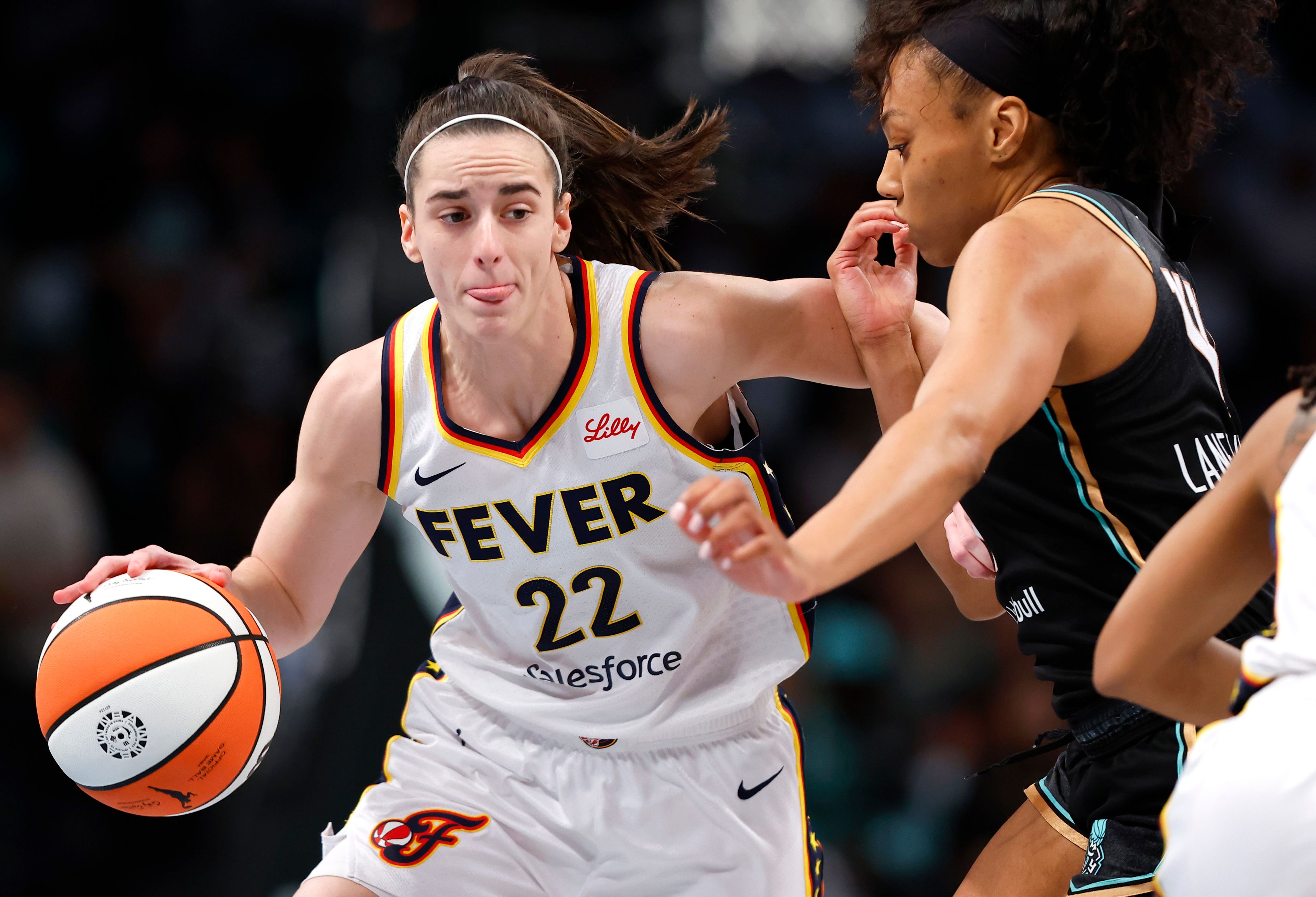 FILE - Indiana Fever guard Caitlin Clark (22) drives to the basket against New York Liberty forward Betnijah Laney-Hamilton (44) during the first half of a WNBA basketball game, Saturday, May 18, 2024, in New York.