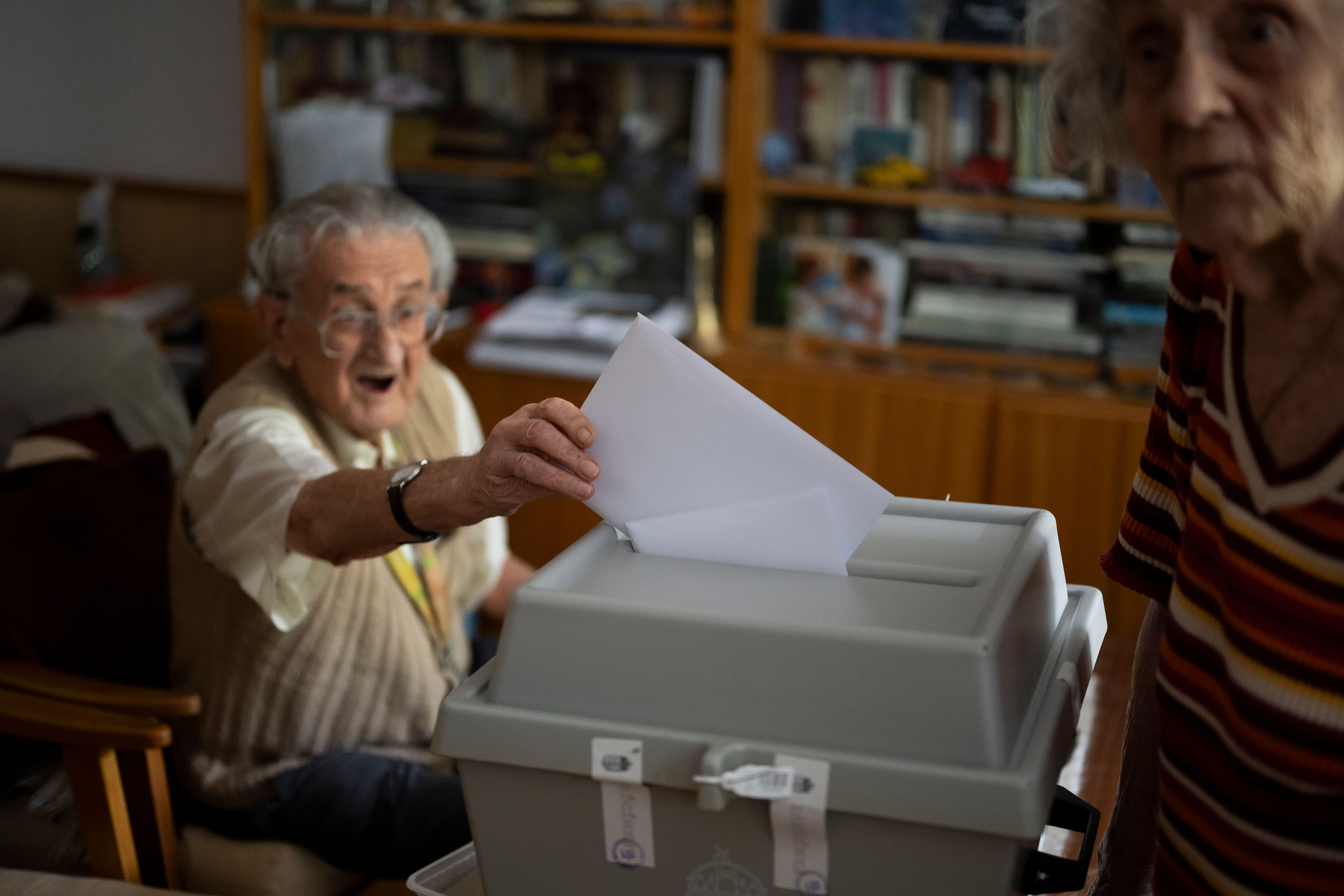 An elderly man casts his ballot in a mobile ballot box during European Parliamentary elections, in Budapest, Hungary, Sunday, June 9, 2024.