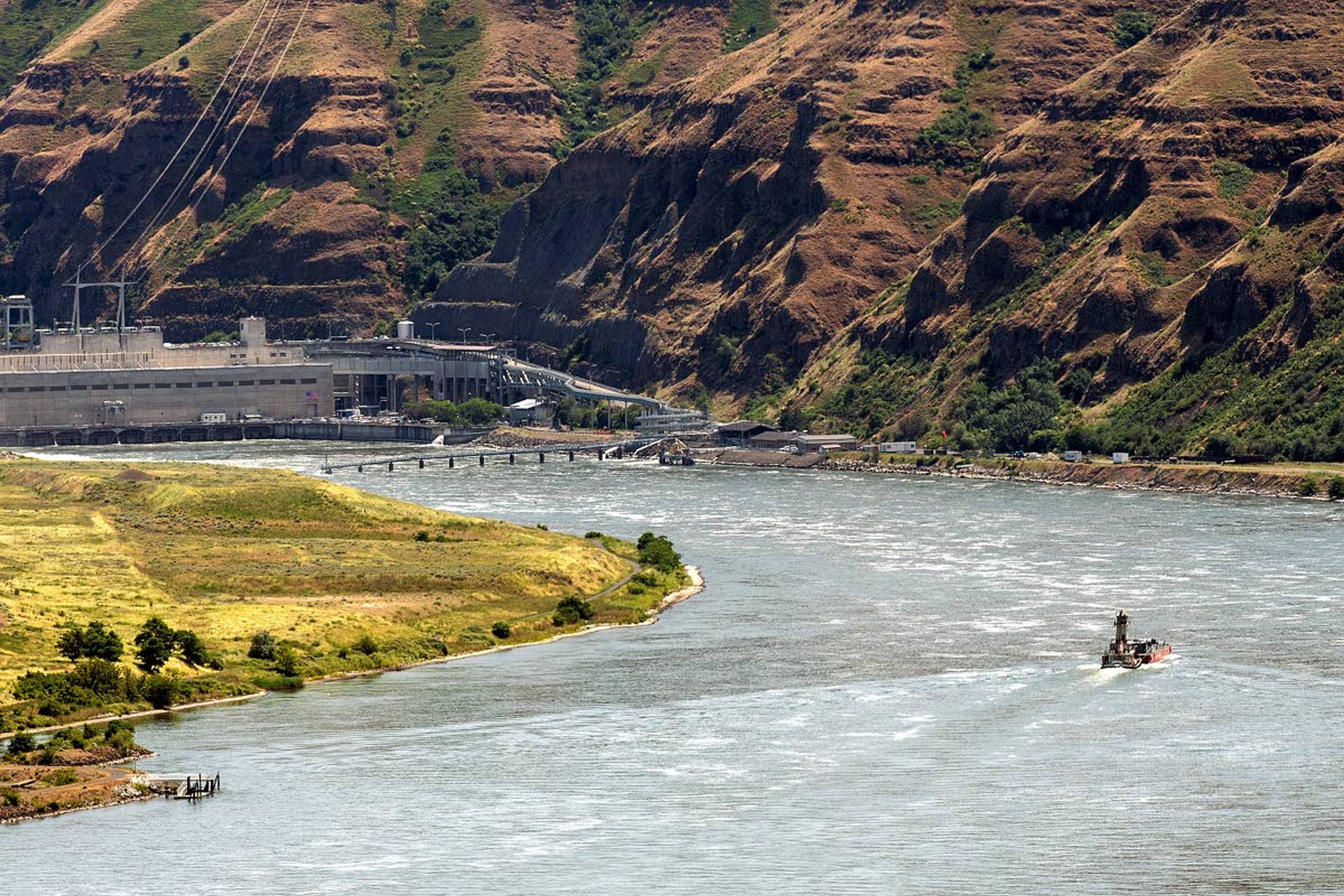 A tug boat and barge head upstream on the Snake River below Lower Granite Dam. Gov. Brad Little’s Salmon Working Group will convene in Lewiston Thursday and Friday to discuss possible salmon recover policy positions.