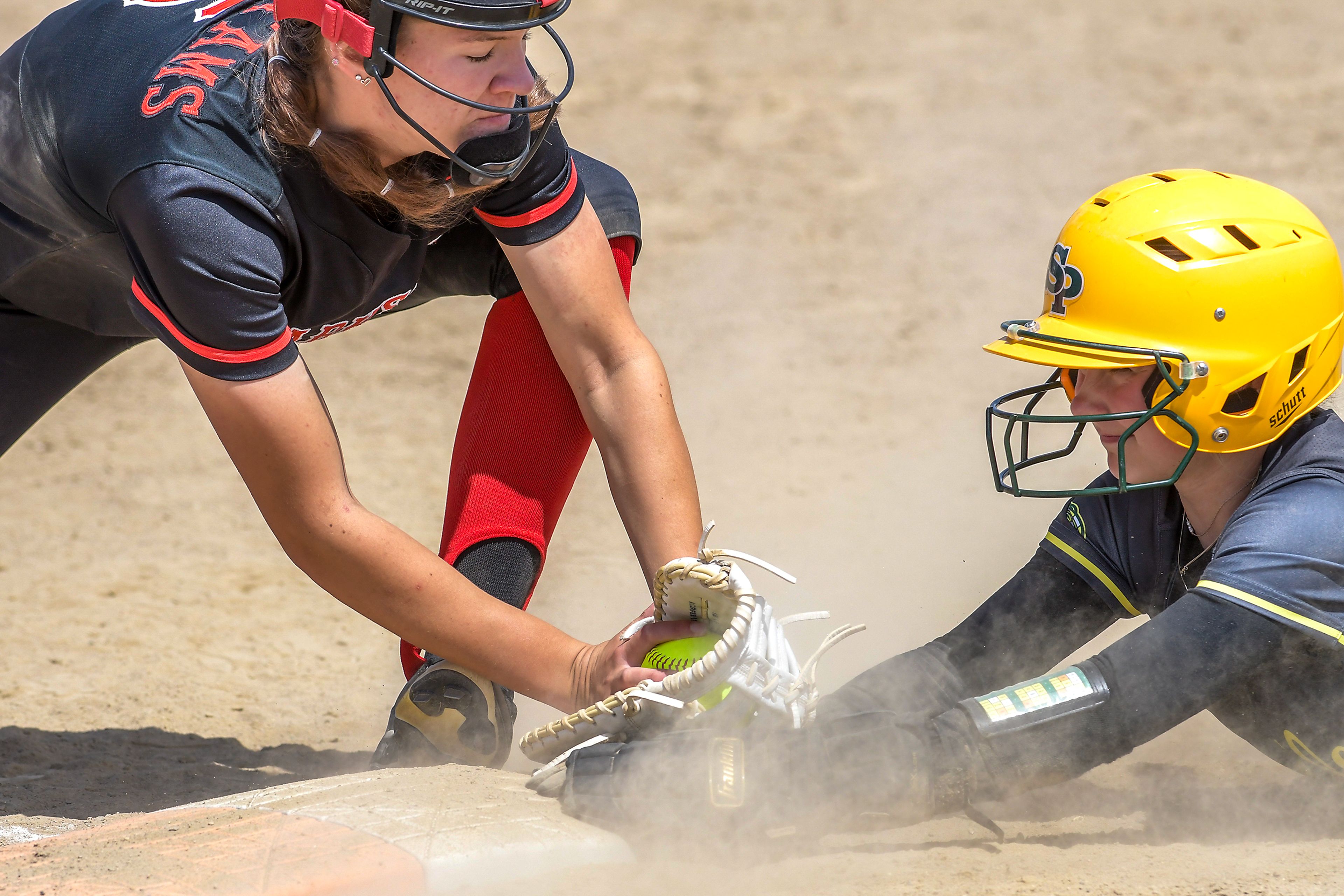 Clarkston first baseman Murray Broemeling attempts to tag out Shadle Park’s Abby Smith on a dive back to first base during an inning of the District Championship Game Saturday in Clarkston.