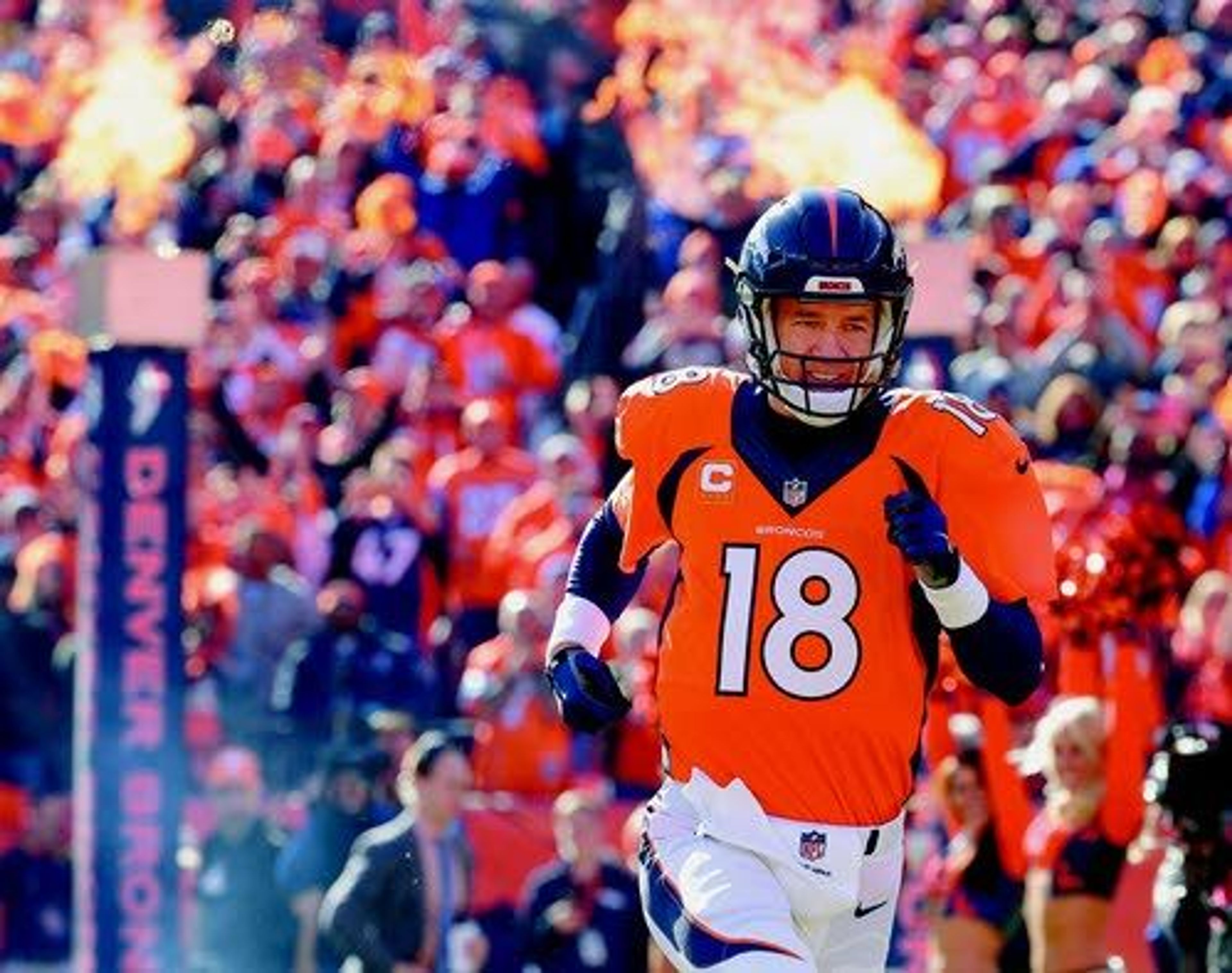 Denver Broncos quarterback Peyton Manning runs onto the field for the first half the AFC Championship game Jan. 24 in Denver.