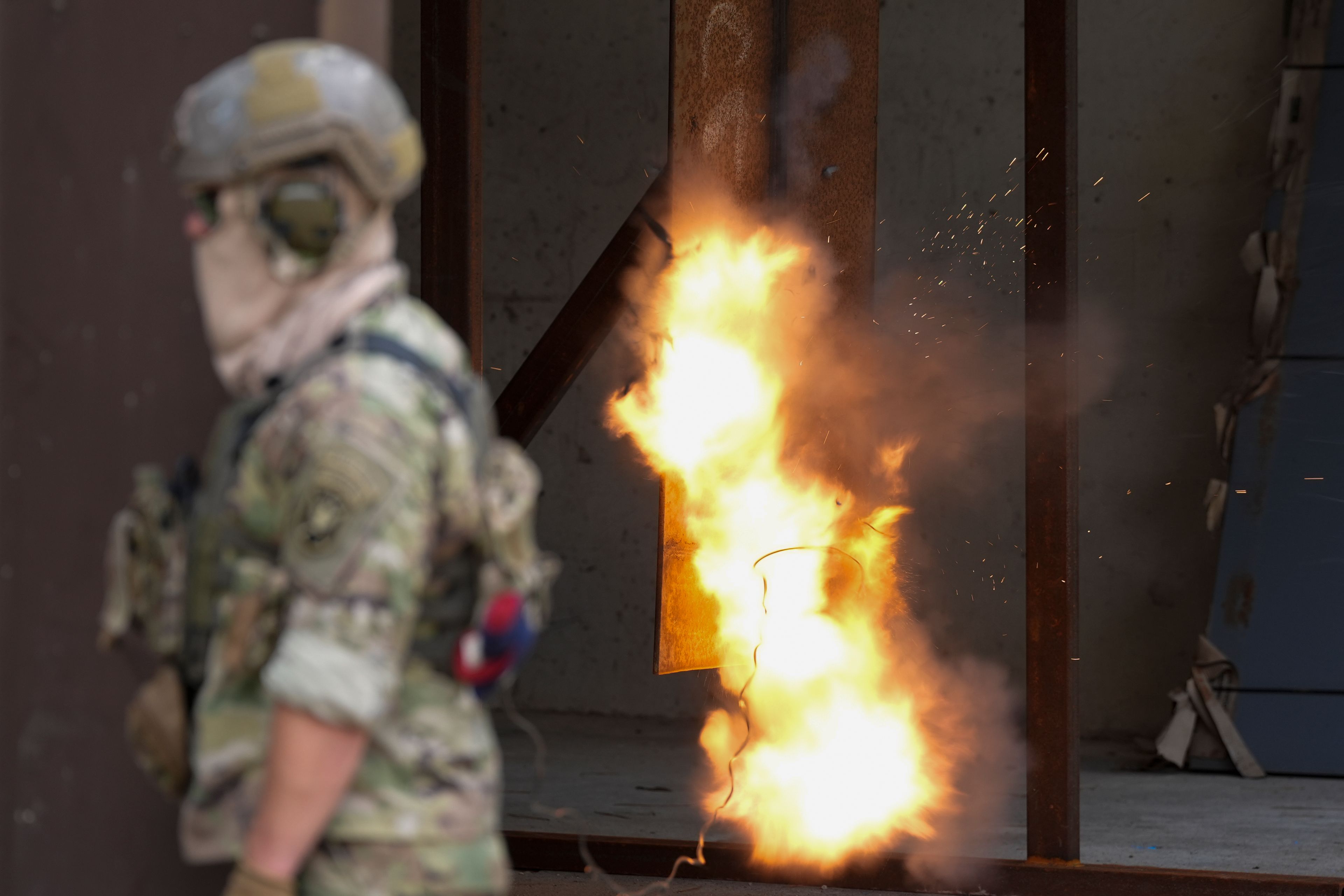 A U.S. special forces soldier sets off a reshaped explosive charge that's noticeably smaller to reduce its blowback on troops, Thursday, Sept. 19, 2024, at at Fort Liberty in Fayetteville, N.C. Special Operations Command is developing ways to better protect warfighters and evaluate their health risks, particularly during training. (AP Photo/Chris Carlson)