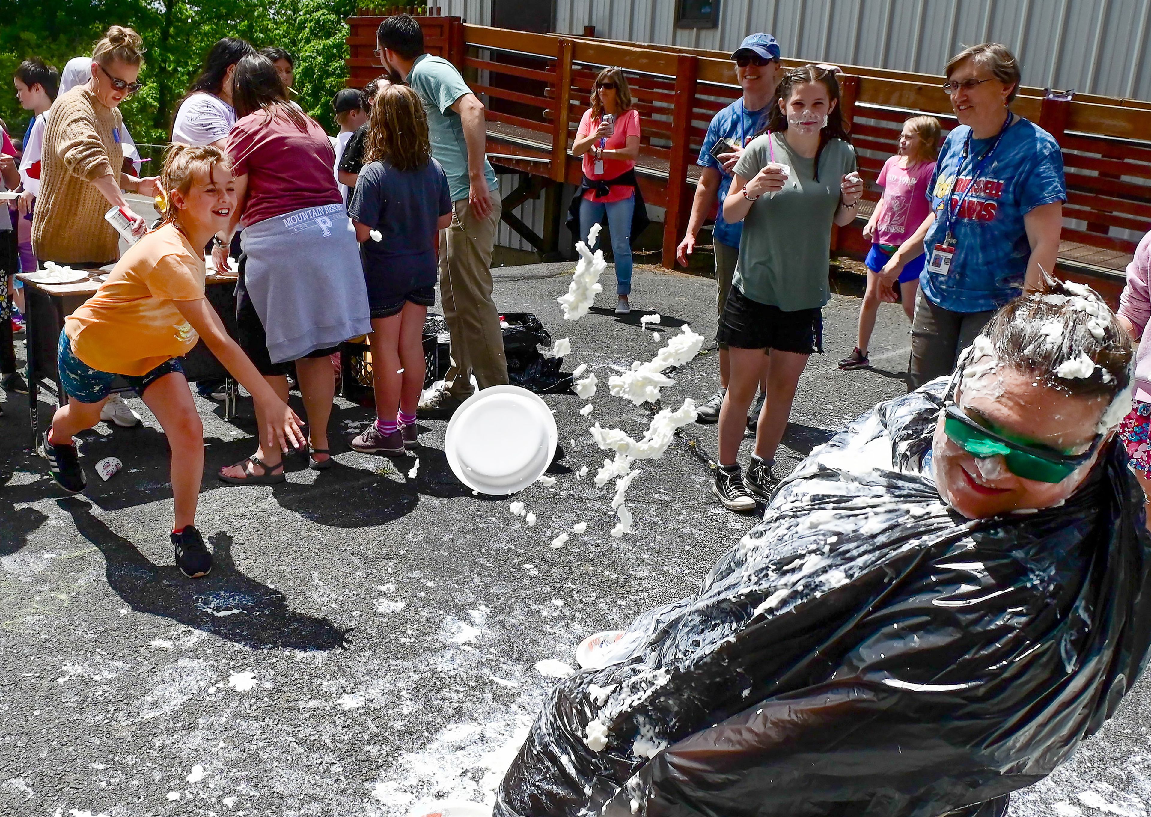 Fourth-grader Aryiah Ermel, left, throws a plate of whip cream at school principal Marianne Sletteland, right, at J. Russell Elementary School’s final day of school field day celebration on Wednesday in Moscow.