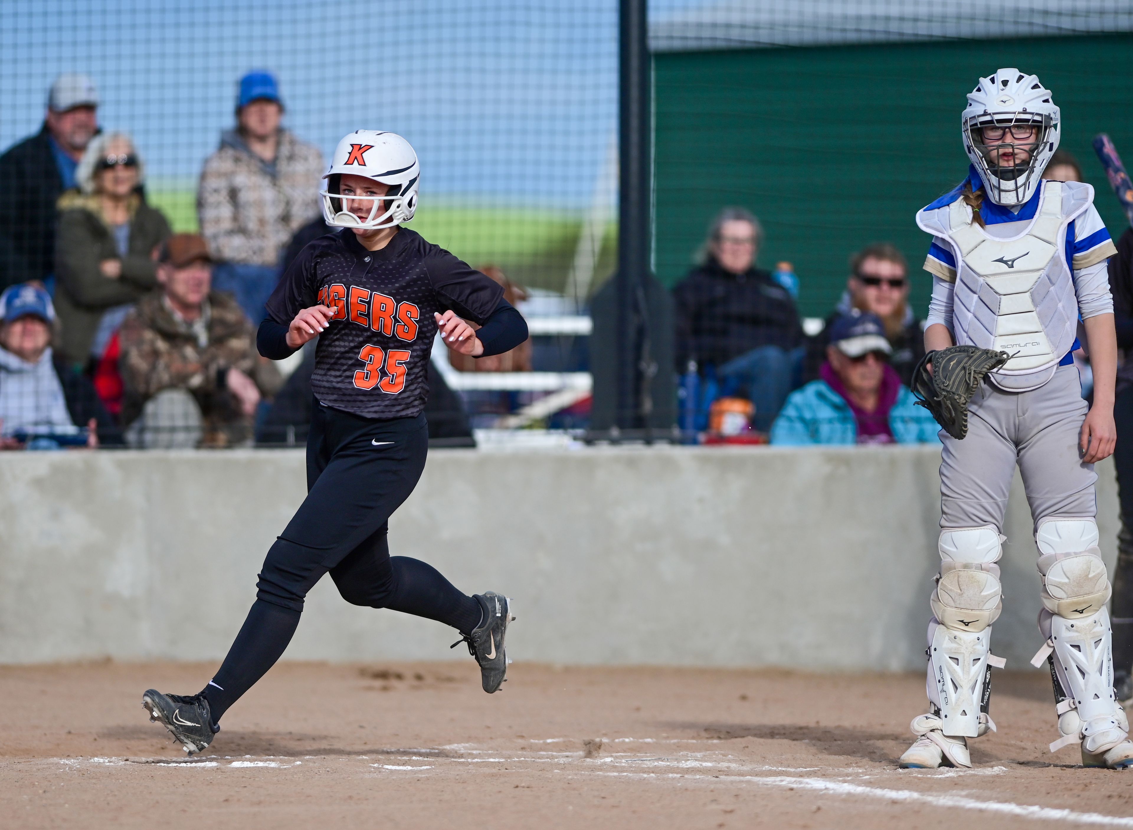 Kendrick’s Lily Hanson crosses the home plate during an Idaho 2A district tournament championship game Wednesday in Genesee.