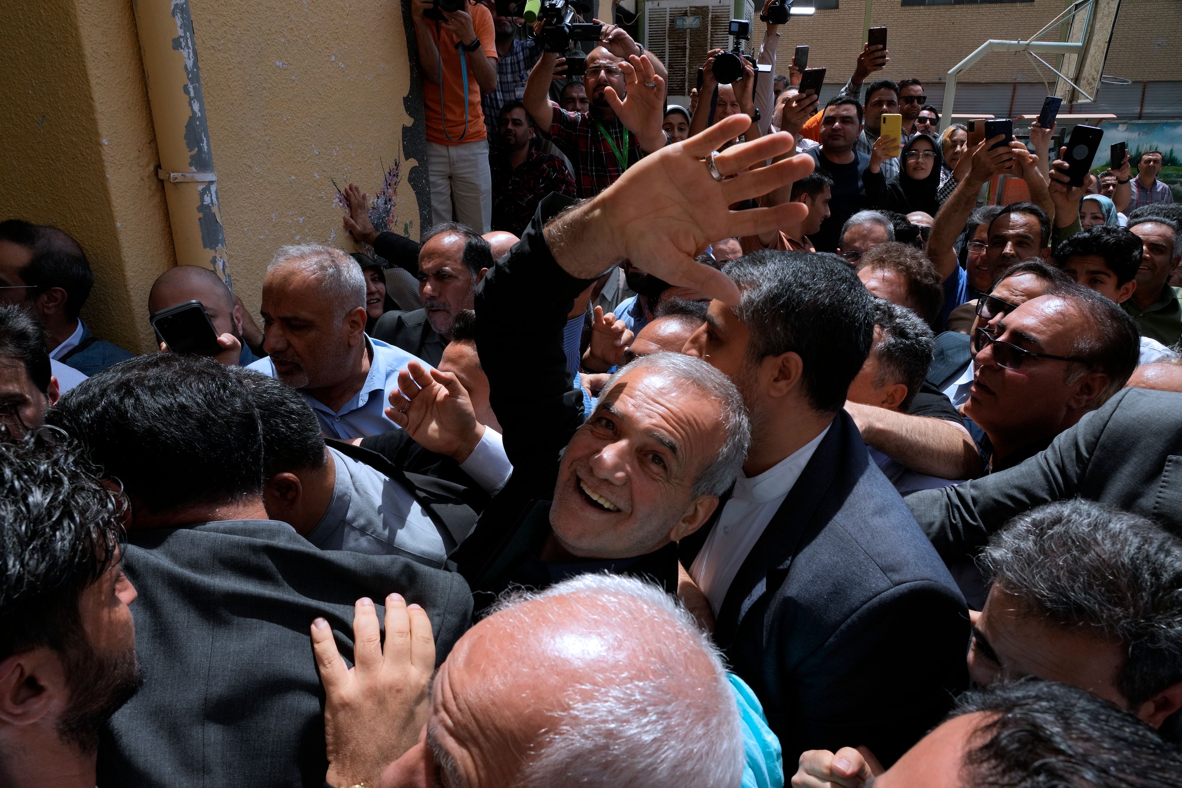 Reformist candidate for the Iran's presidential election Masoud Pezeshkian waves as he arrives to vote at a polling station in Shahr-e-Qods near Tehran, Iran, Friday, July 5, 2024. Iranians began voting Friday in a runoff election to replace the late President Ebrahim Raisi, killed in a helicopter crash last month, as public apathy has become pervasive in the Islamic Republic after years of economic woes, mass protests and tensions in the Middle East. (AP Photo/Vahid Salemi)