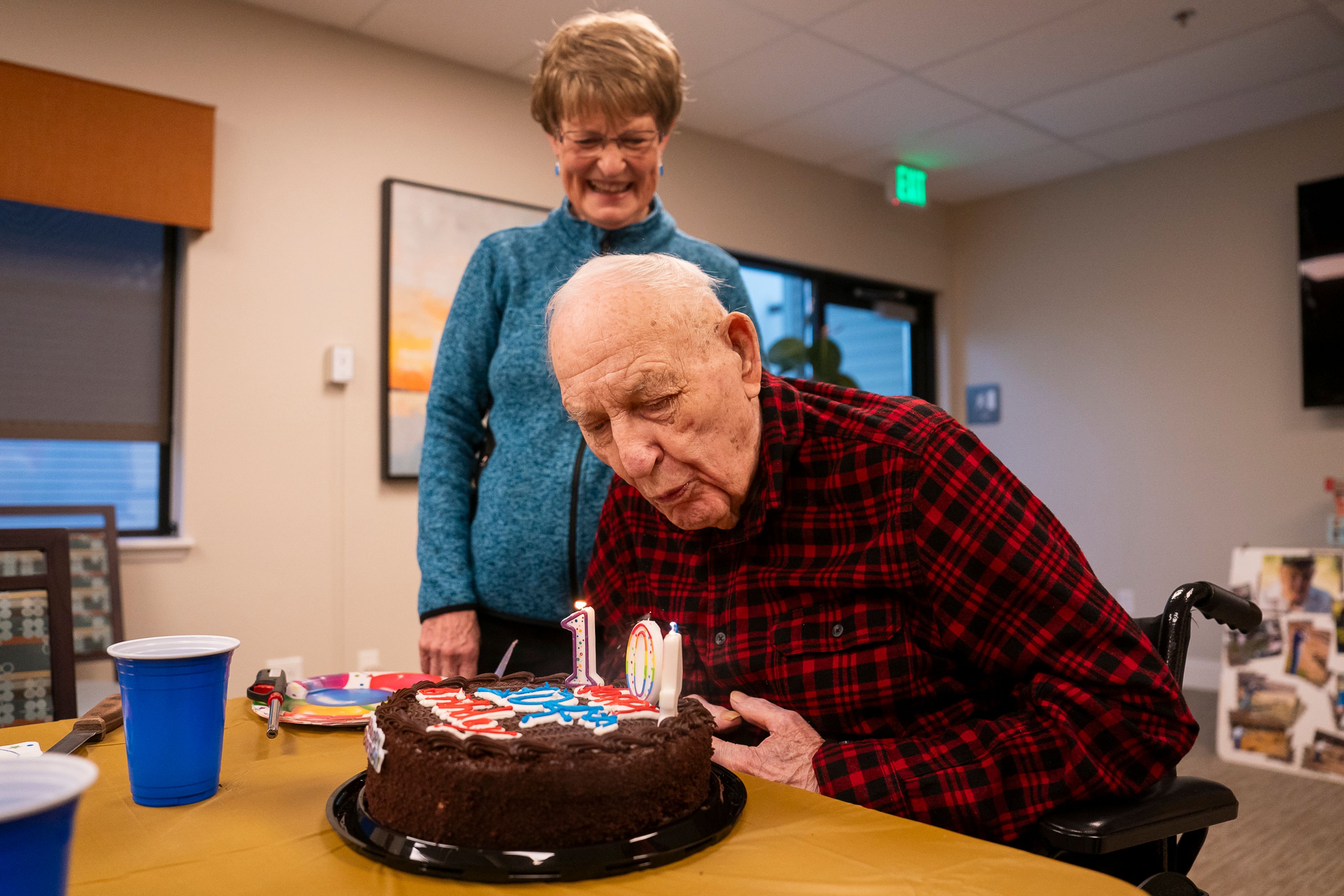 Lawrence “Dutch” Kuykendall blows out the candles of a cake during his 104th birthday party on Tuesday inside Evergreen Estates in Clarkston.