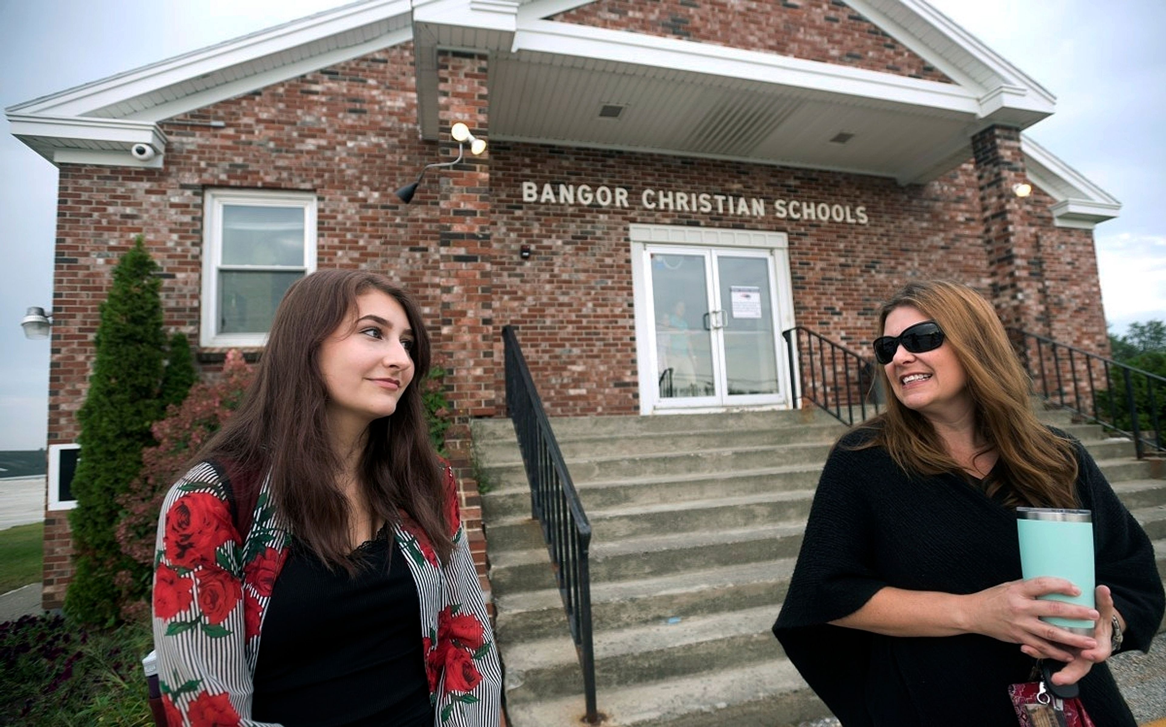 FILE - Olivia Carson, then a 15-year-old sophomore, of Glenburn, Maine, left, stands with her mother Amy outside the Crosspoint Church-affiliated Bangor Christian Schools on August 28, 2018 in Bangor, Maine.