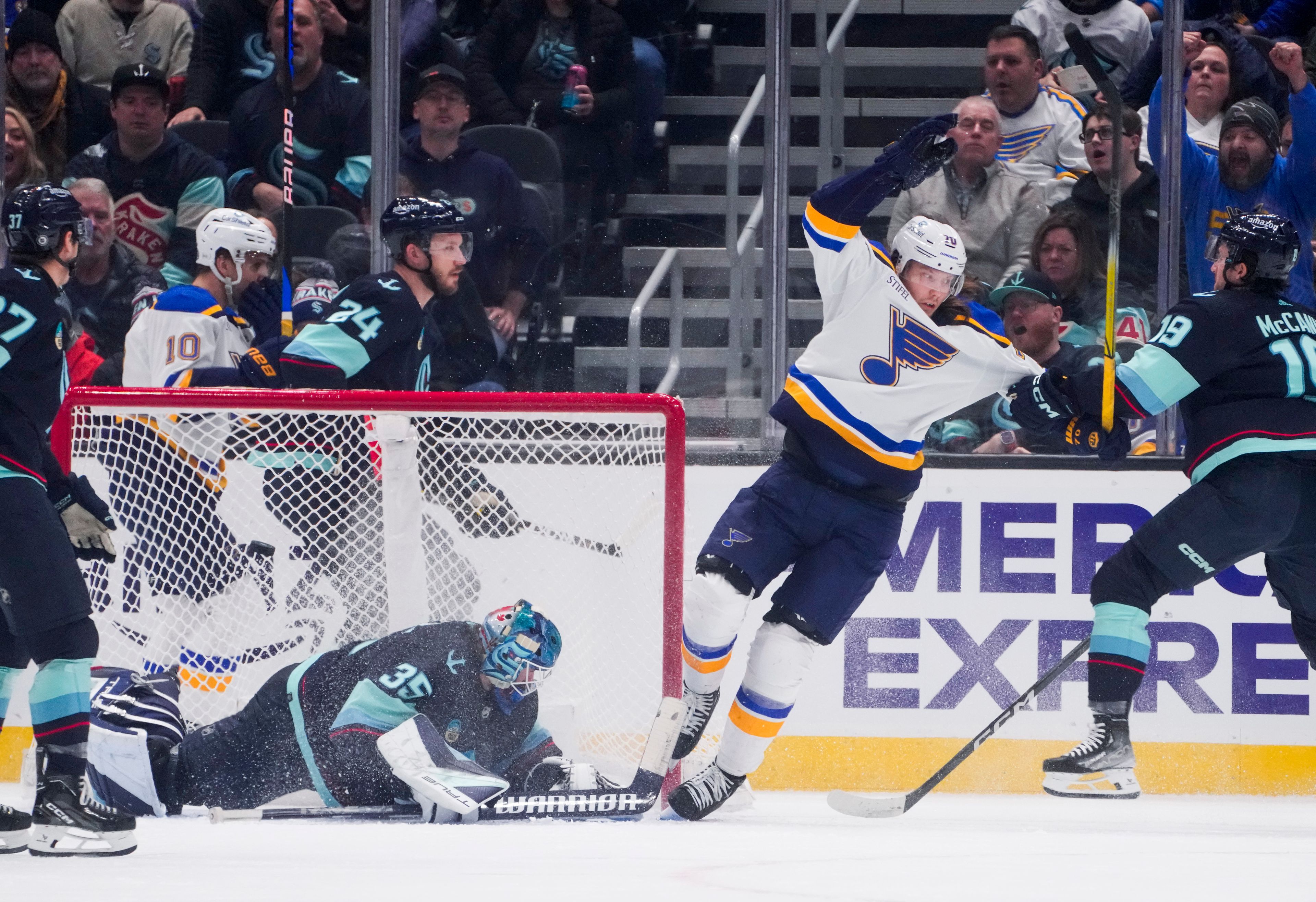 Blues center Oskar Sundqvist (70) trips after scoring against Kraken goaltender Joey Daccord (35) during the first period of a game Friday in Seattle.