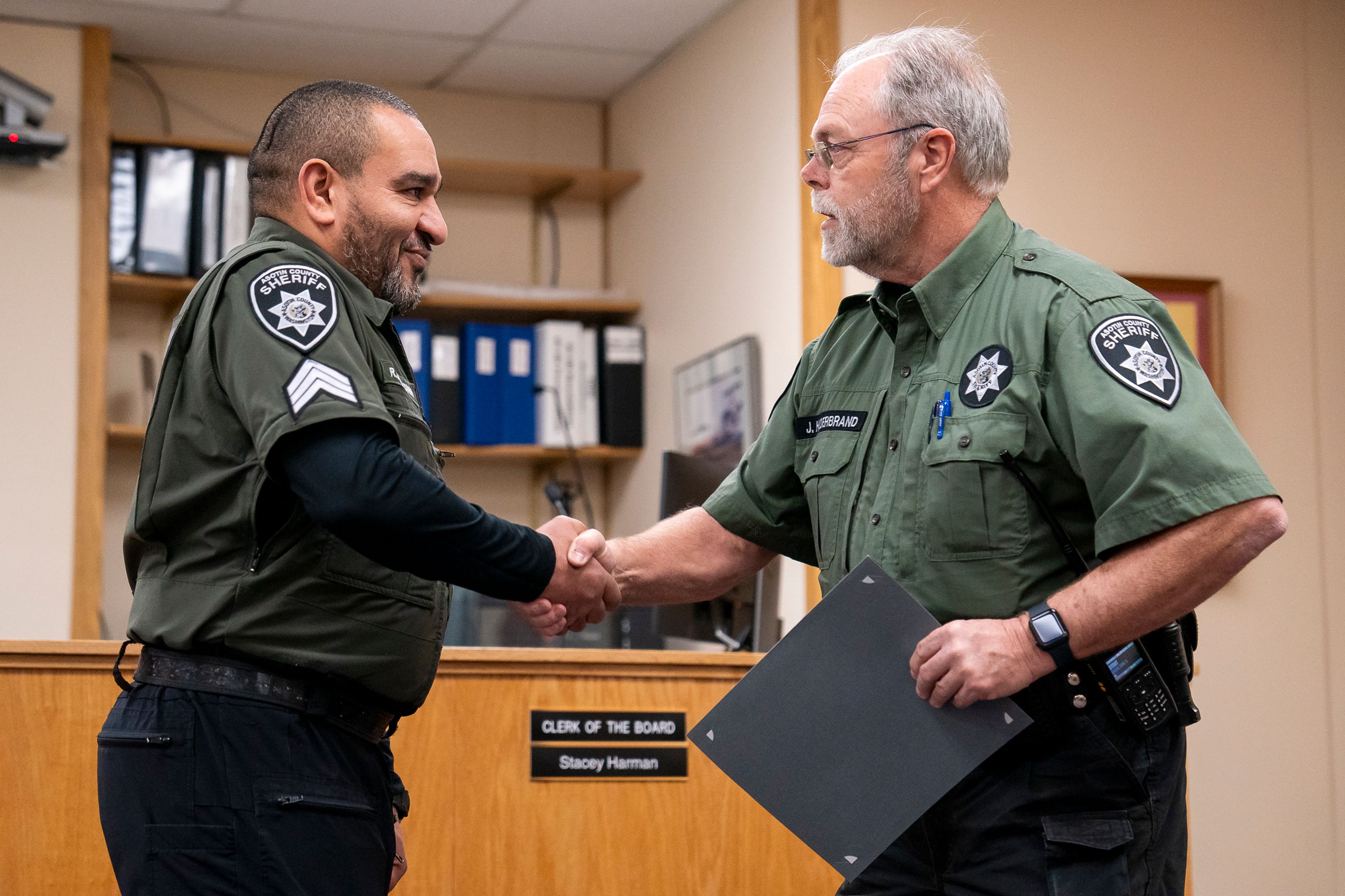 Asotin County Sheriff John Hilderbrand, right, shakes Rashid Bensultana’s hand as he is promoted to Sergeant on Thursday afternoon inside the Asotin County Courthouse Annex.