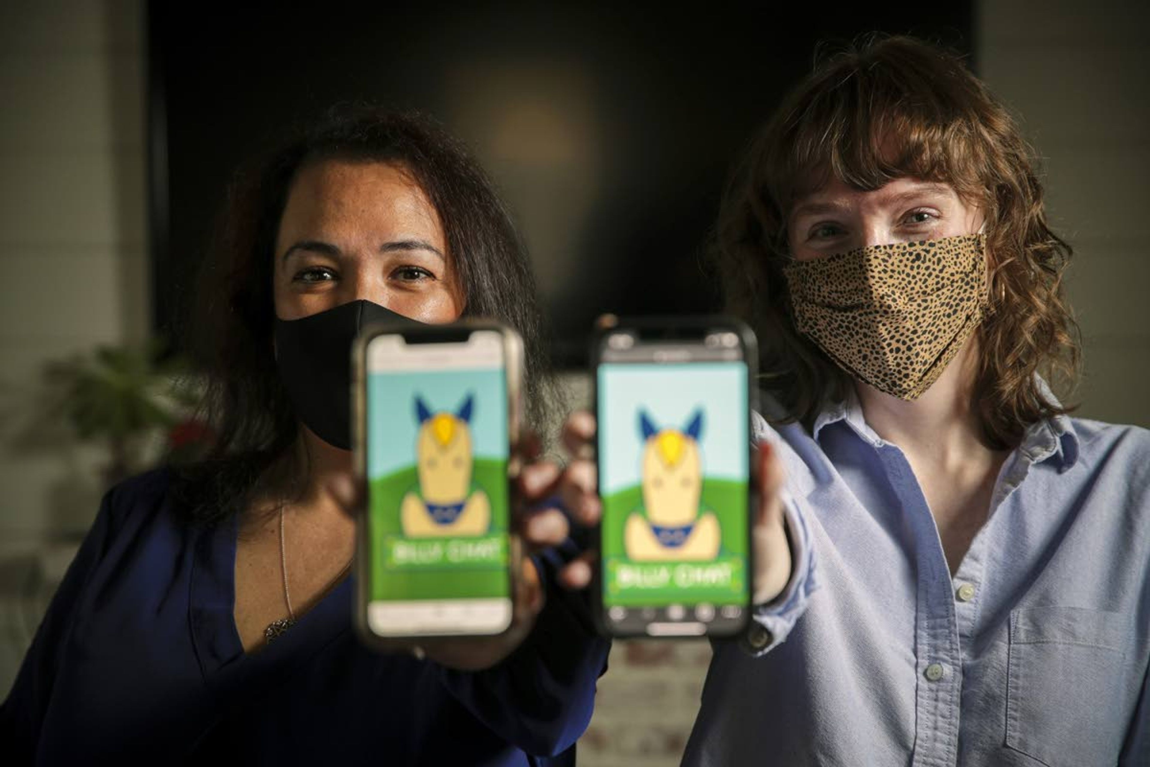 Cecilia Santiago-Gonzalez, assistant vice president of Strategic Initiatives for Student Success, left, and Zoe Lance, communication specialist, are managers of Billy Chat, an artificial intelligence text messaging robot for student communication at Cal Poly Pomona. They are shown March 5 in San Dimas, Calif.