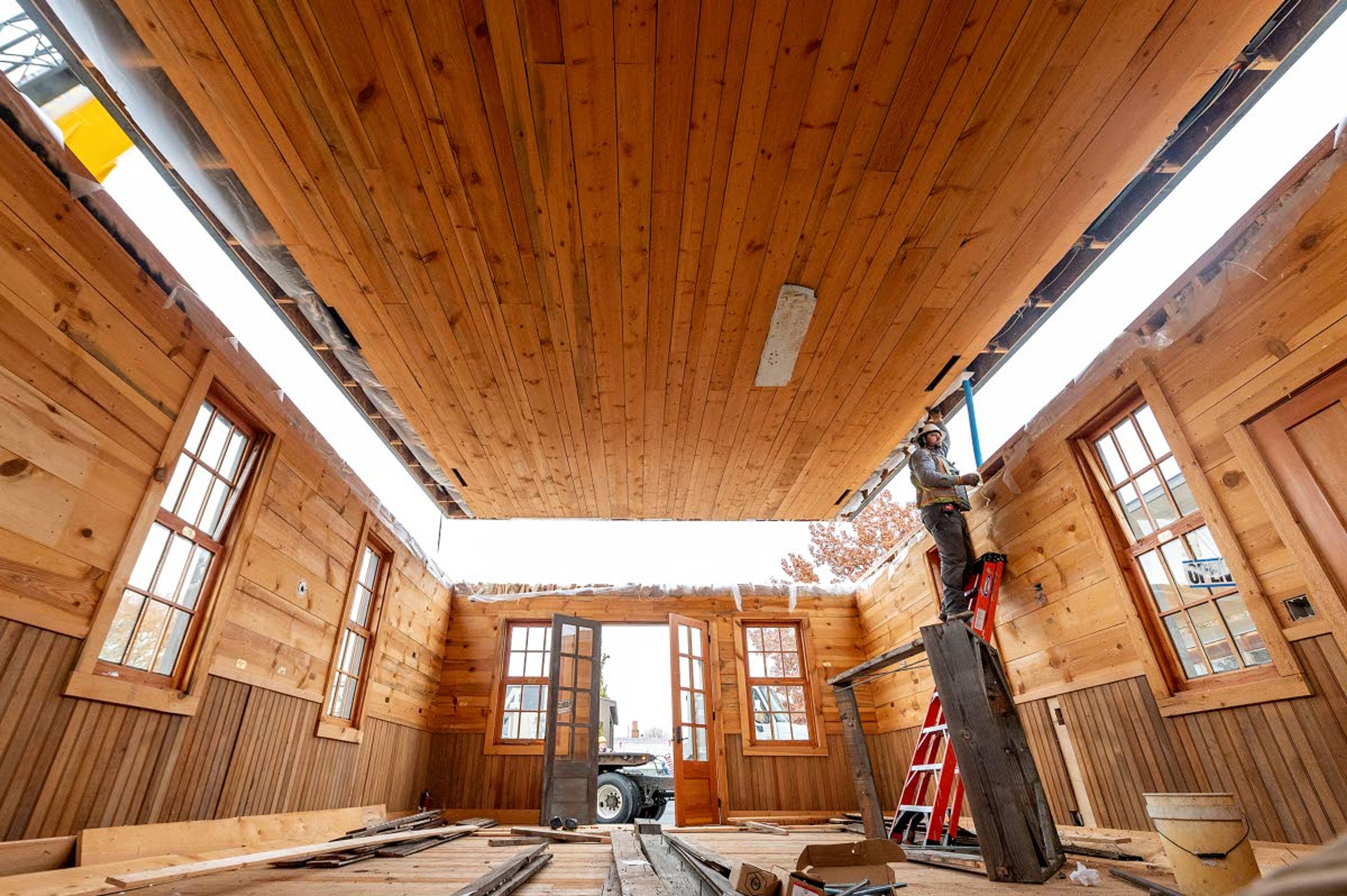 Brian McDermott, owner of Brian McDermott Construction, which was tasked with moving the Idaho Territorial Capitol building, steadies the roof of the building into place at its new home at the Nez Perce County Historical Society and Museum on Tuesday morning in Lewiston.